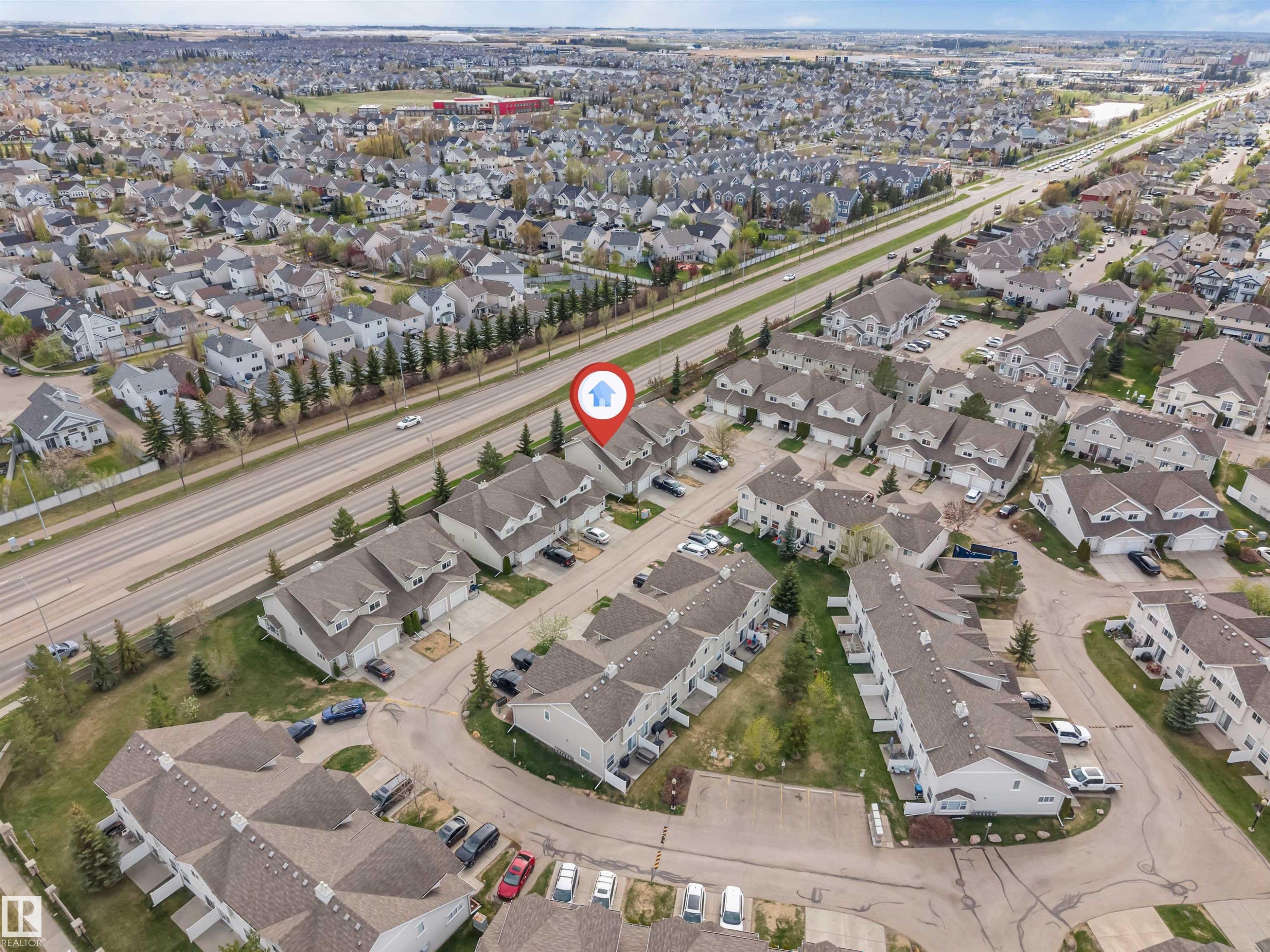 Aerial perspective showcasing a residential community with numerous detached and attached properties - 135 150 Edwards Drive, Edmonton, AB -