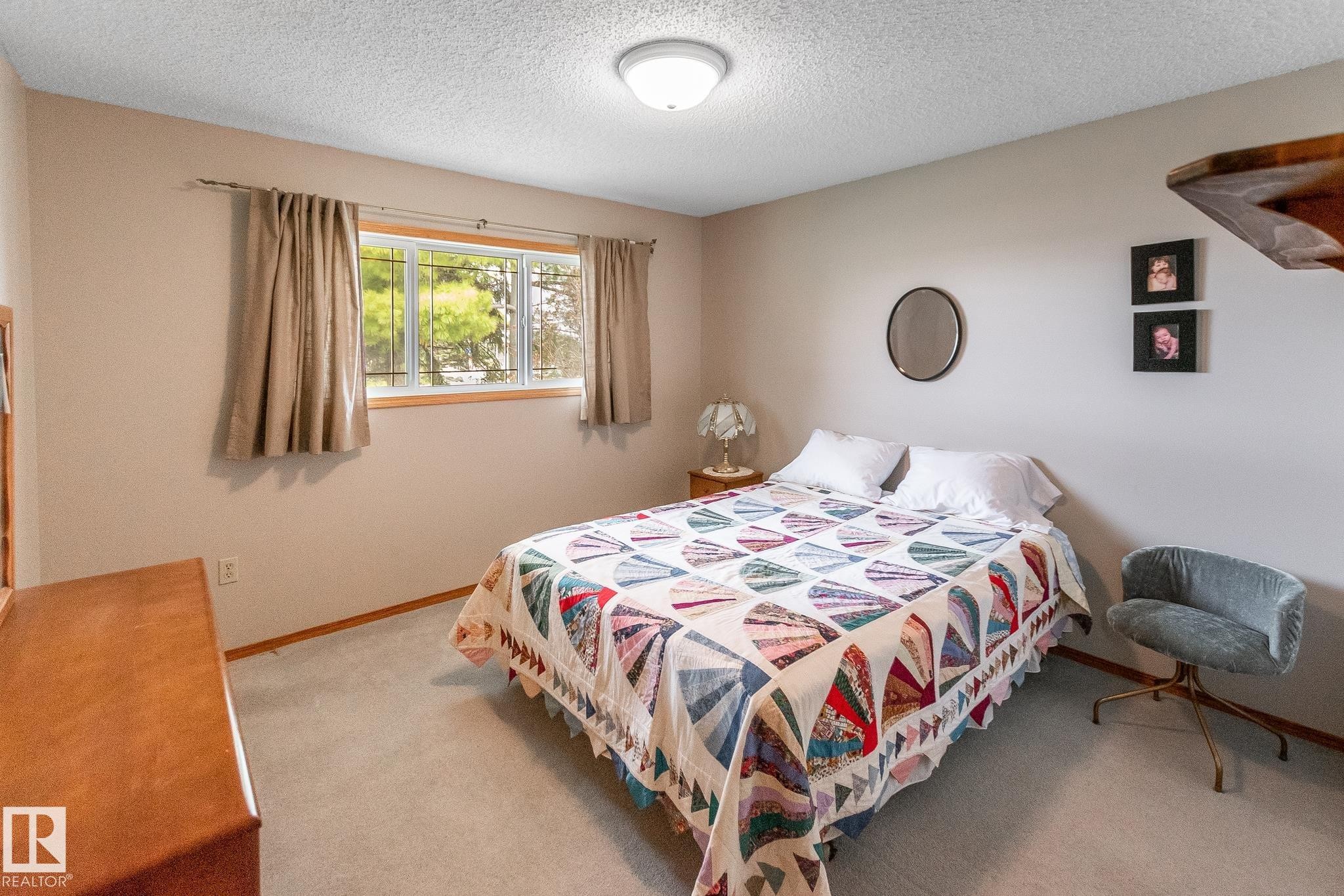 Carpeted room with a ceiling-mounted light fixture - 4611 Lakeshore Drive, Bonnyville Town, AB - Indoor Photo Showing Bedroom