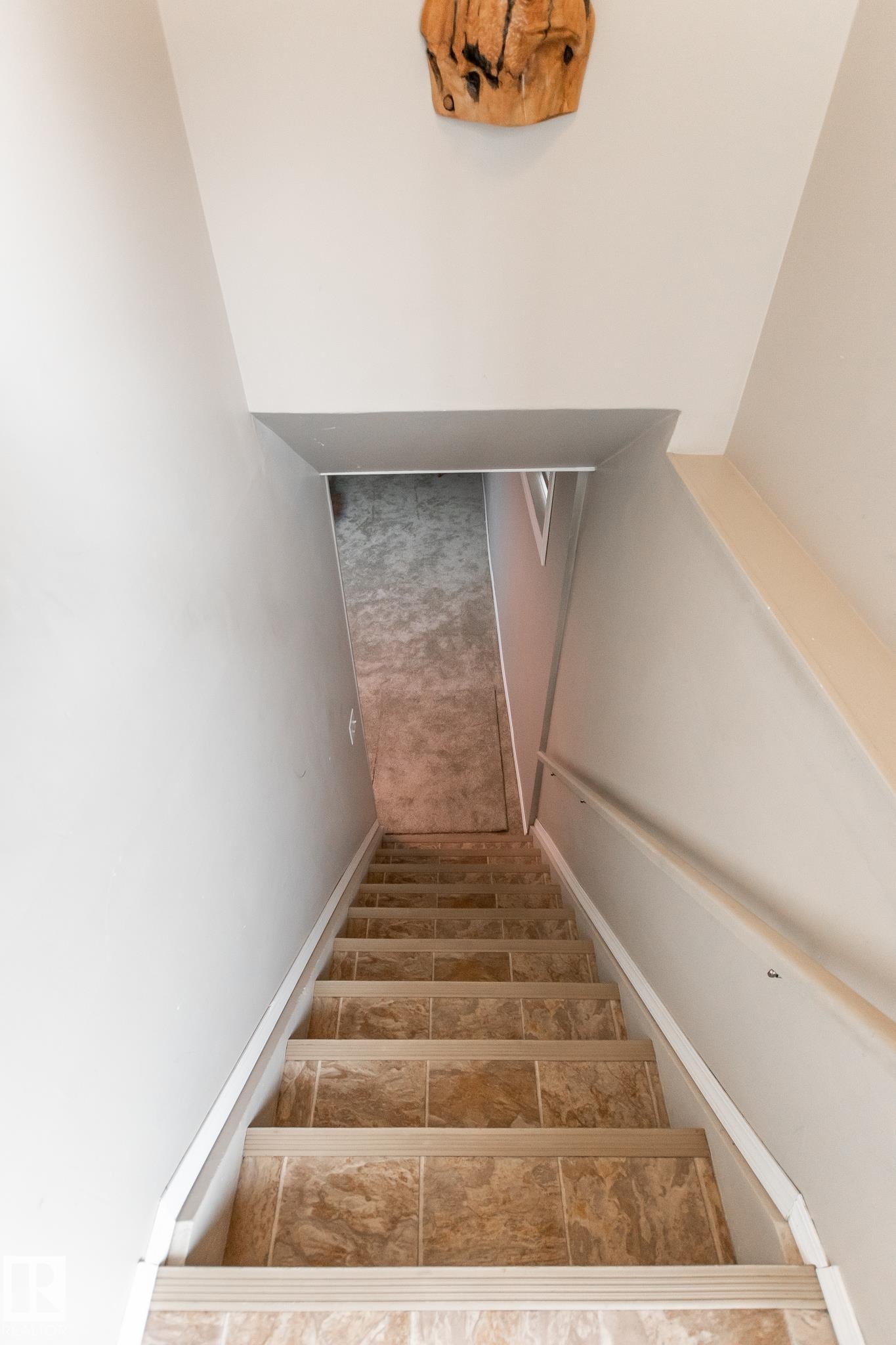 Staircase with tile-finish treads and risers, featuring a handrail and light-toned wall finishes - 4611 Lakeshore Drive, Bonnyville Town, AB - Indoor Photo Showing Other Room