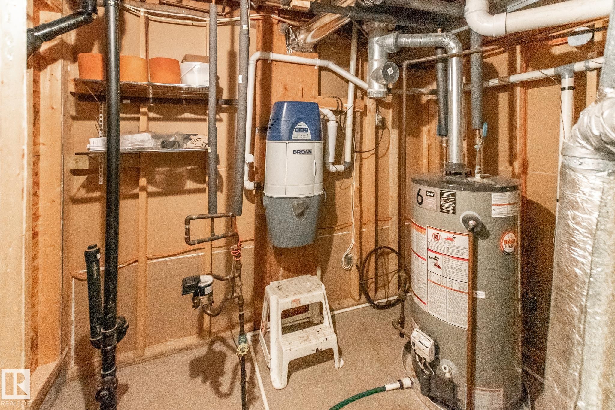 Utility area featuring a water heater, central vacuum system, and exposed plumbing - 4611 Lakeshore Drive, Bonnyville Town, AB - Indoor Photo Showing Basement