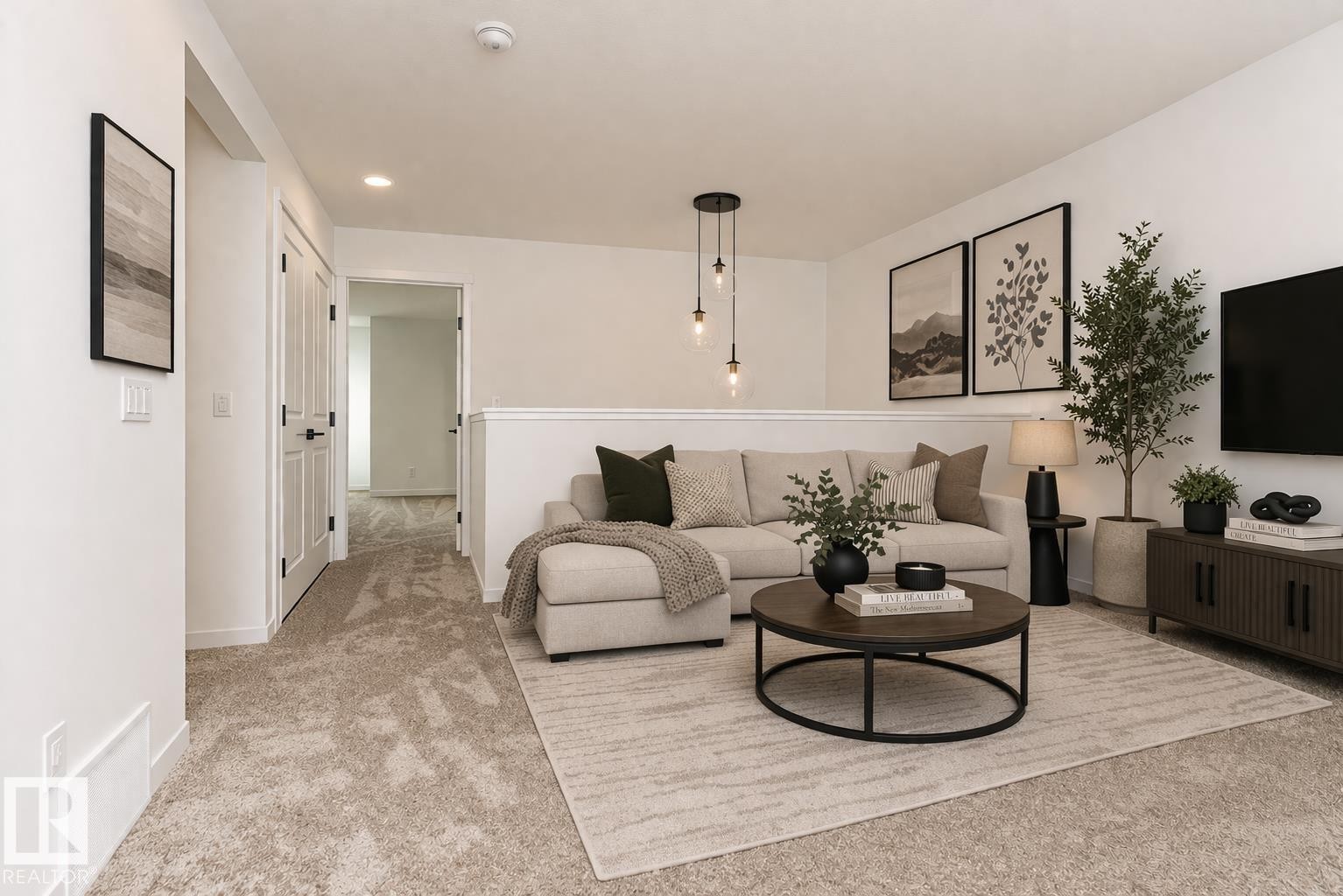 This inviting living area features plush carpeting and a modern chandelier - 2355 Egret Way, Edmonton, AB - Indoor Photo Showing Living Room
