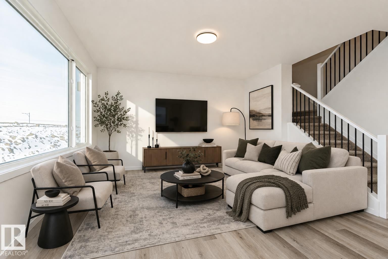 The property features an open living space with light-colored flooring, a large window providing natural light, and a staircase with dark balusters - 2355 Egret Way, Edmonton, AB - Indoor Photo Showing Living Room