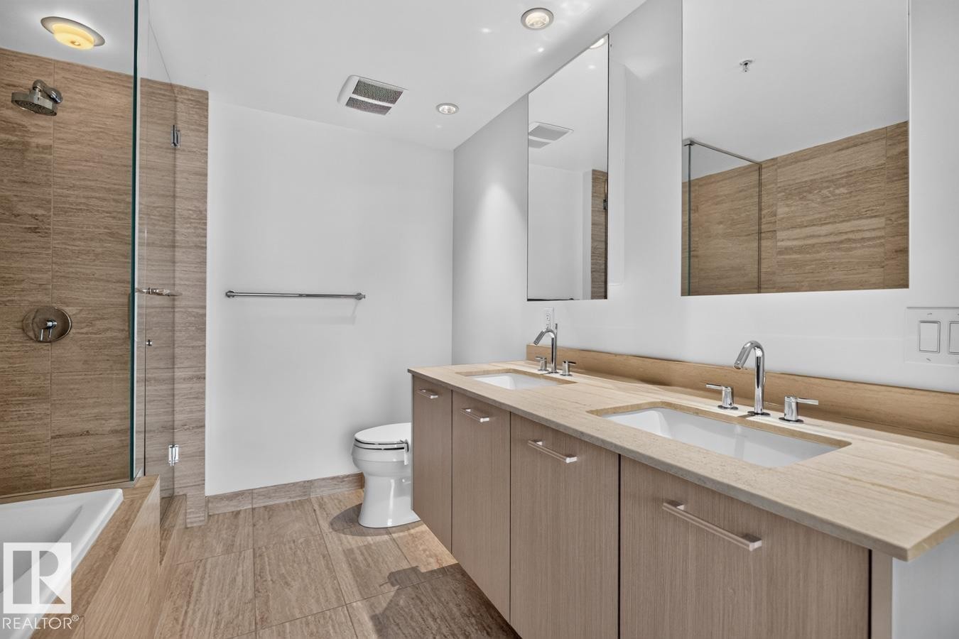 Bathroom featuring a dual vanity with undermount sinks, chrome fixtures, and a light wood-finish countertop - #407 2504 109 St Nw, Edmonton, AB - Indoor Photo Showing Bathroom