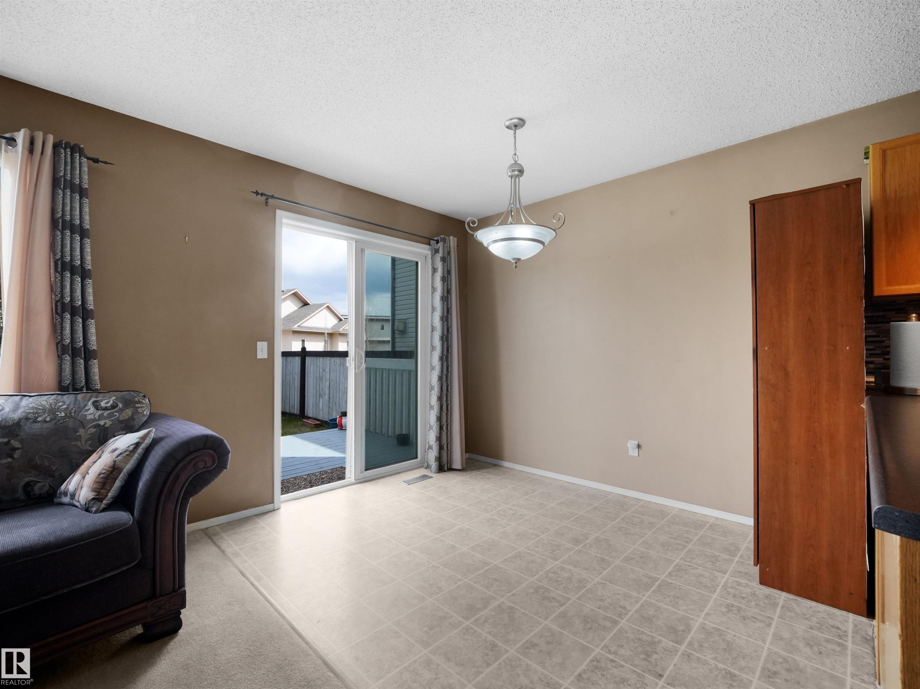 Spacious dining area featuring neutral wall tones and patterned vinyl flooring - 16121 131A Street, Edmonton, AB - Indoor