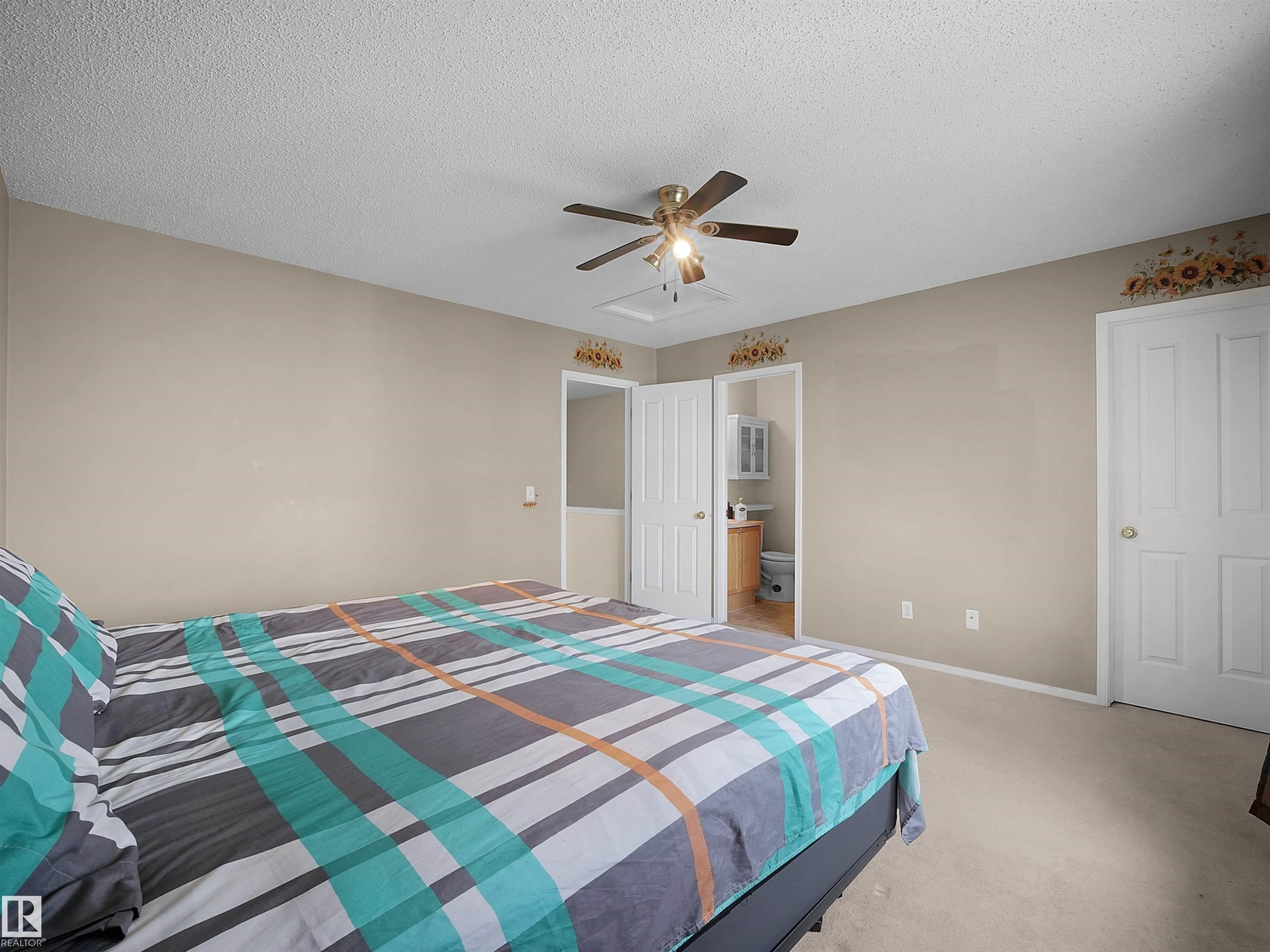 Carpeted room with a ceiling fan light fixture and a light neutral wall color - 16121 131A Street, Edmonton, AB - Indoor Photo Showing Bedroom