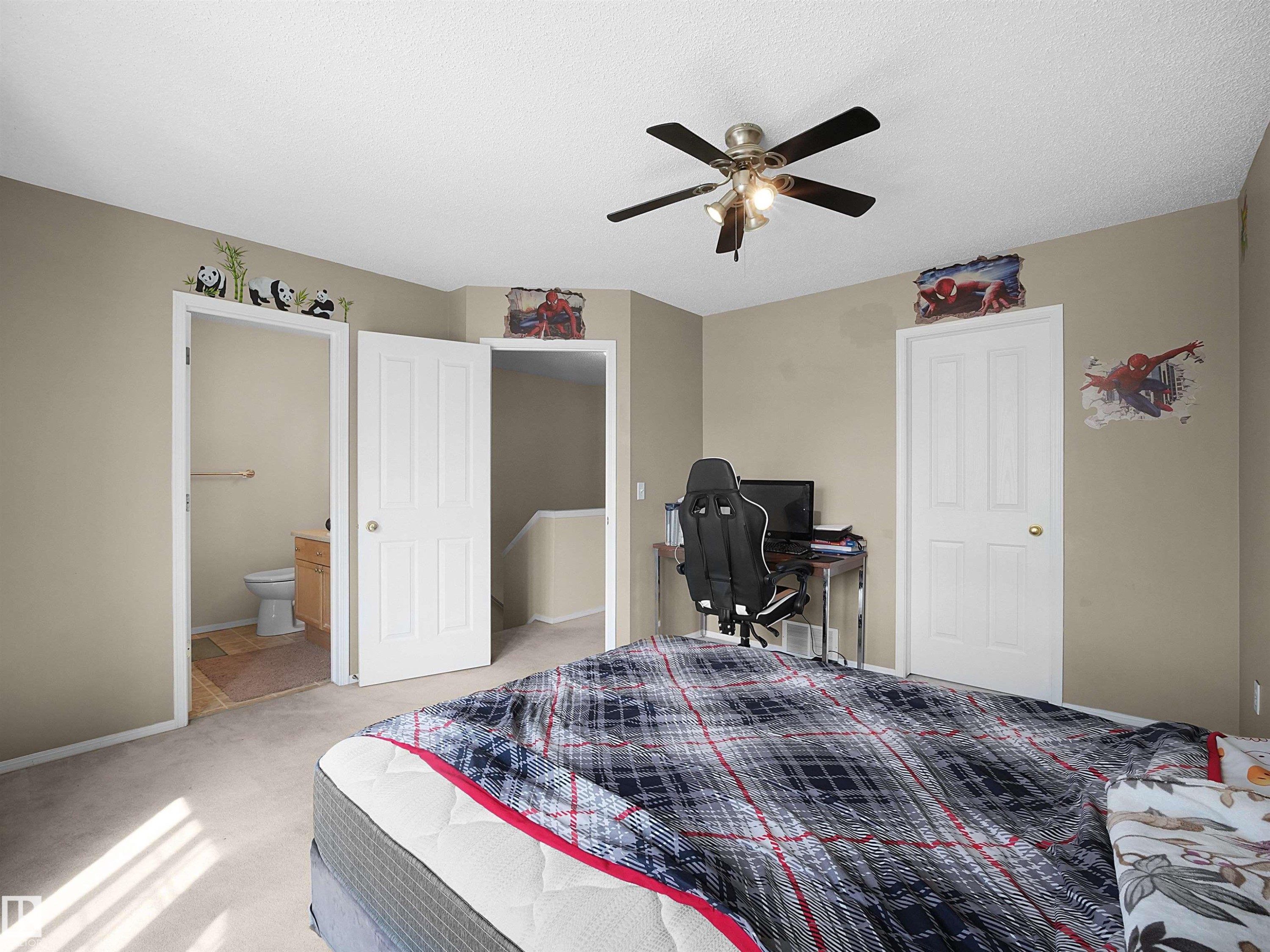 Carpeted room featuring a ceiling fan with integrated lighting, neutral wall tones, and white interior doors - 16121 131A Street, Edmonton, AB - Indoor Photo Showing Bedroom