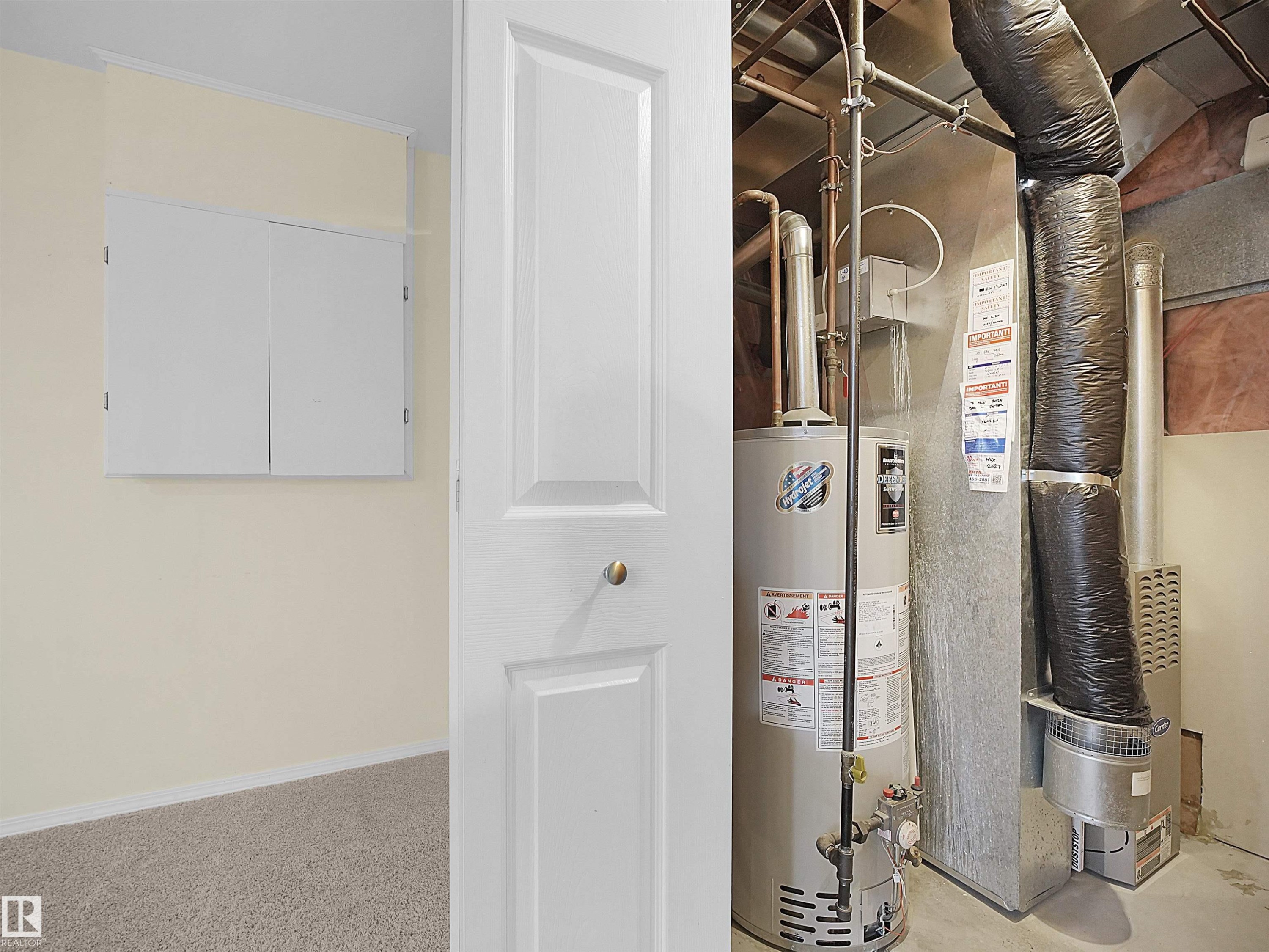 Utility closet featuring a water heater, furnace, and exposed ductwork - 16121 131A Street, Edmonton, AB - Indoor Photo Showing Basement