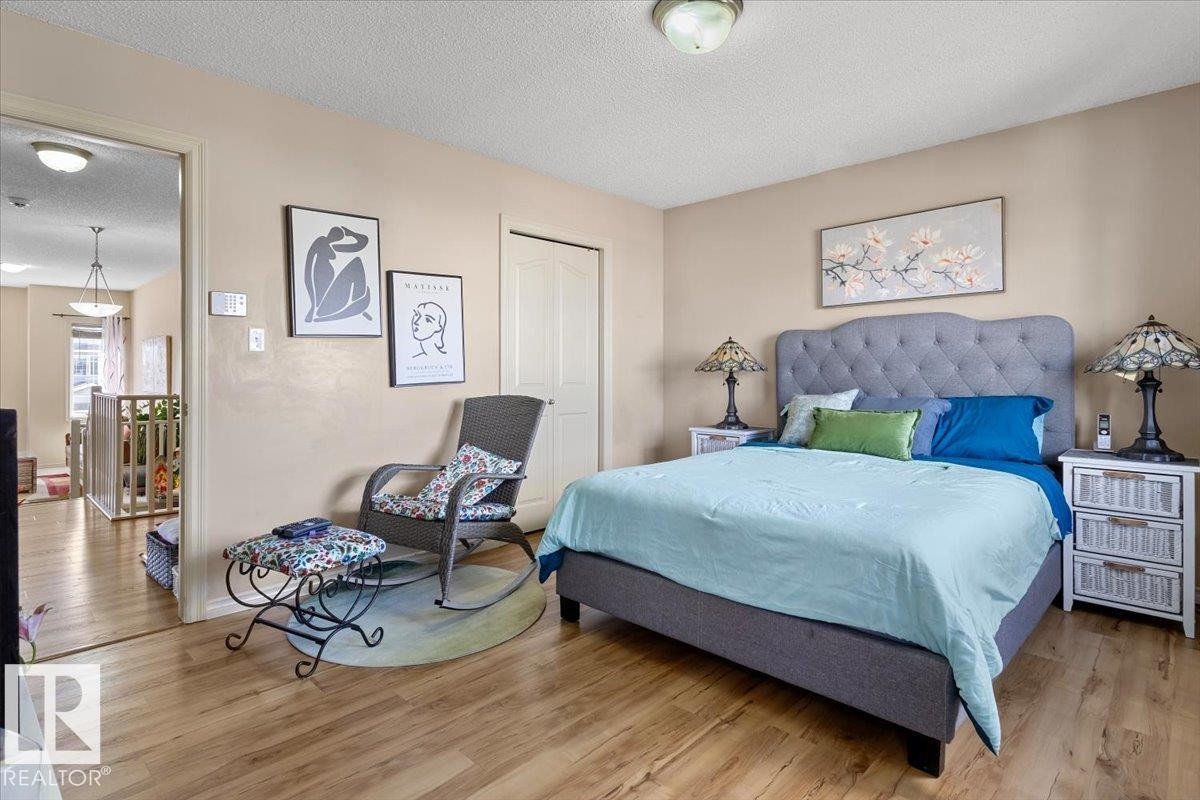 Bedroom featuring wood-finish flooring and neutral wall tones - 3356 25 Ave, Edmonton, AB - Indoor Photo Showing Bedroom