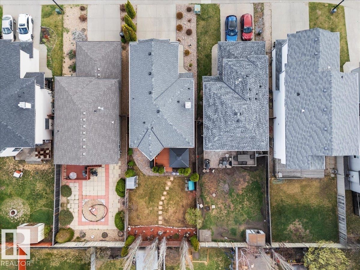 Overhead view showcasing three residential properties with gray shingle roofs - 3356 25 Ave, Edmonton, AB - Outdoor