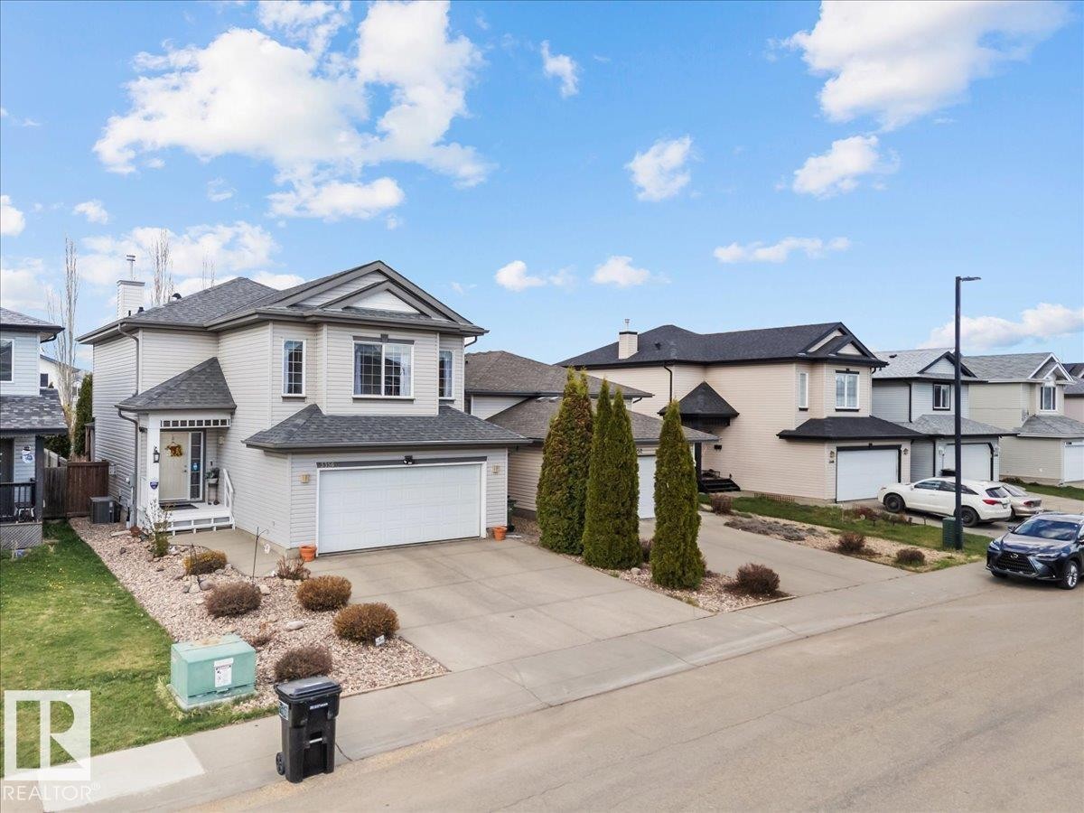 Two-story residence featuring light-colored siding and a dark shingle roof - 3356 25 Ave, Edmonton, AB - Outdoor With Facade