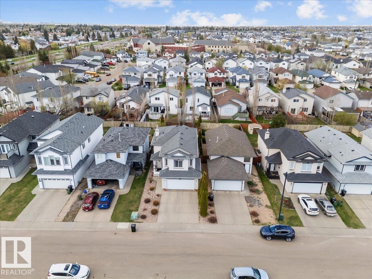 Suburban residential neighborhood featuring multiple detached homes with asphalt shingle roofs and integrated garages - 3356 25 Ave, Edmonton, AB - Outdoor With View