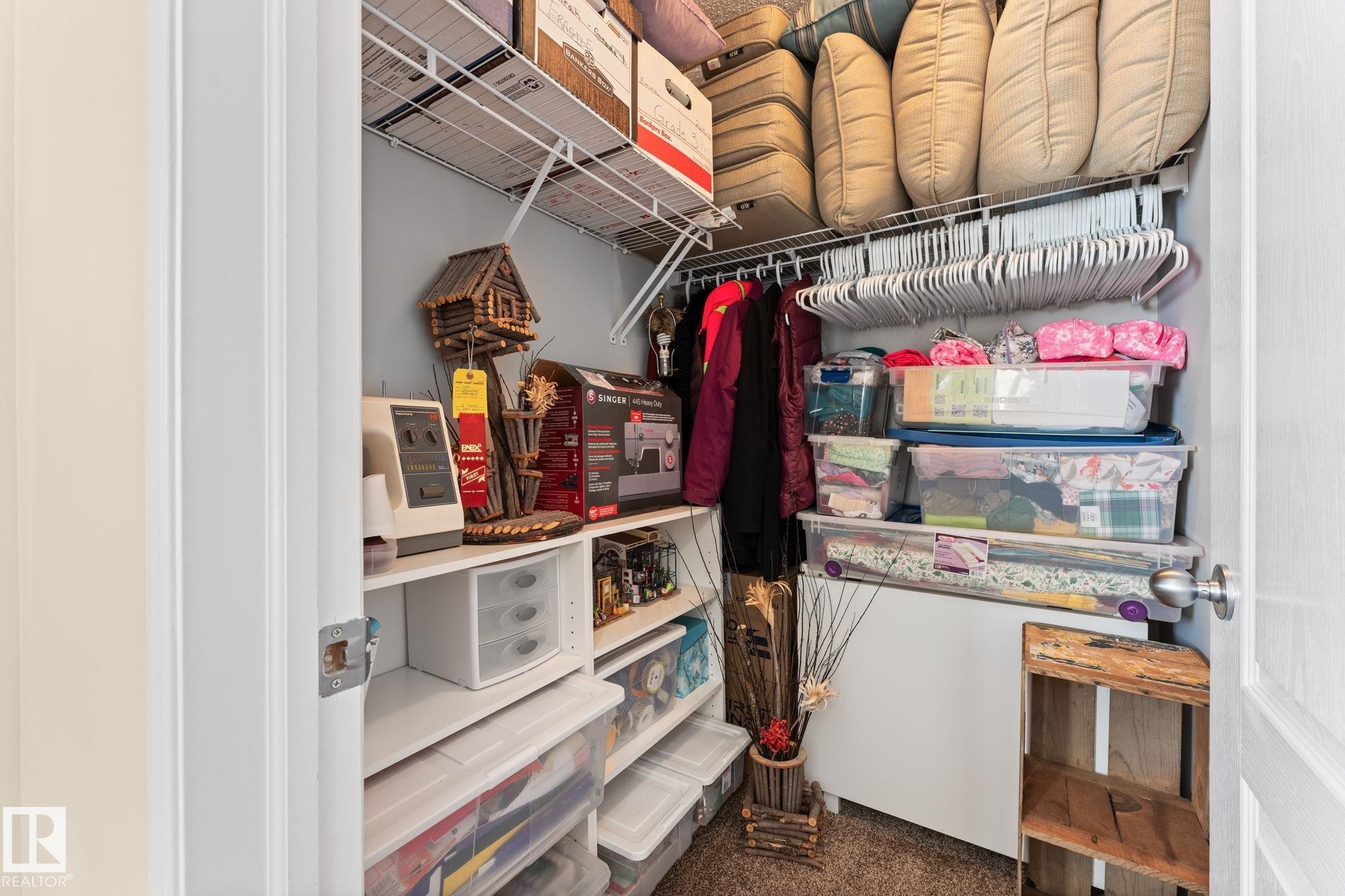 Closet featuring wire shelving, built-in rod, light gray wall paint, and white trim - 112 Lakeland Point(E), Beaumont, AB - Indoor With Storage