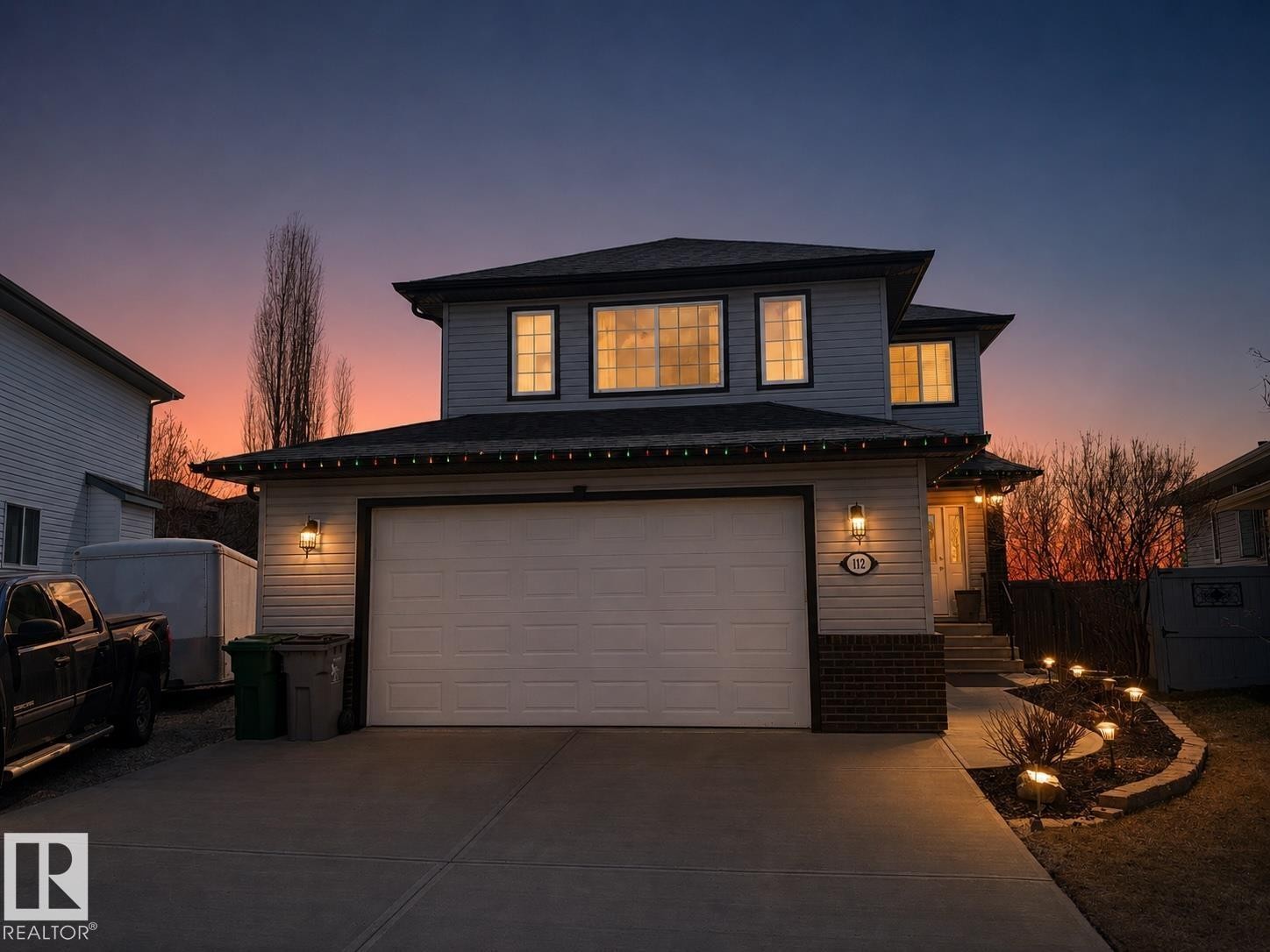 Two-story residence featuring light siding and a dark roof - 112 Lakeland Point(E), Beaumont, AB - Outdoor