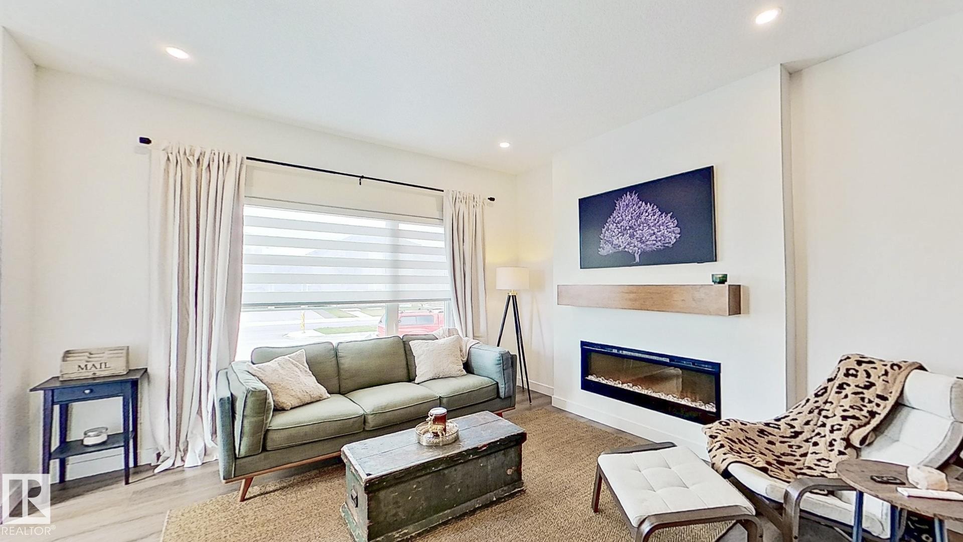37 Emberside Link, Cochrane, AB - Indoor Photo Showing Living Room With Fireplace