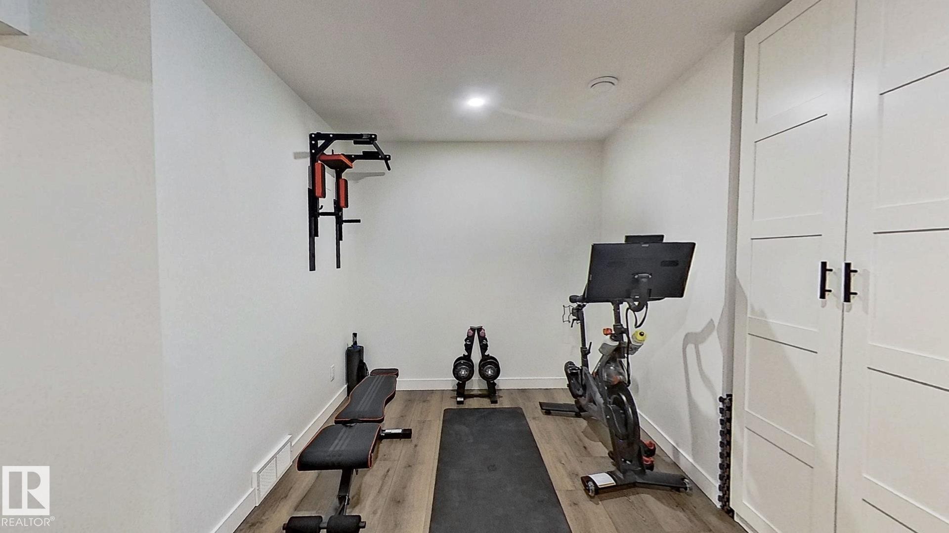 37 Emberside Link, Cochrane, AB - Indoor Photo Showing Gym Room