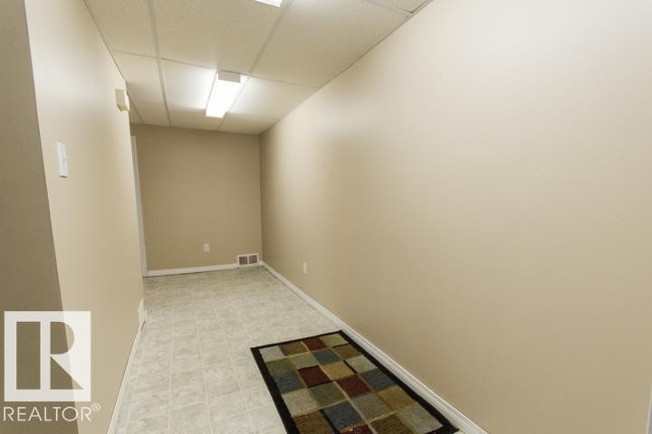 The property features light-colored walls, tile flooring, and ceiling lights - 10806 64 Avenue, Edmonton, AB - Indoor