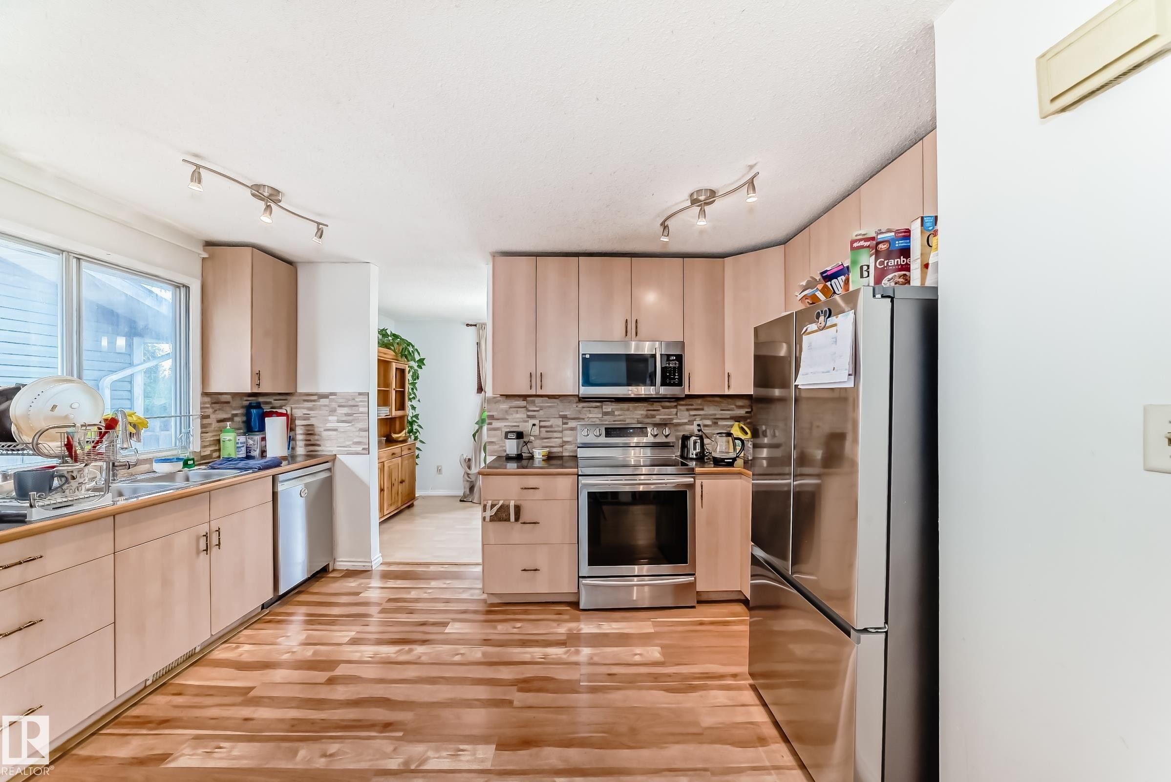 Kitchen featuring wood-finish flooring and light wood cabinetry - 1804 51 Street Nw, Edmonton, AB - Indoor Photo Showing Kitchen