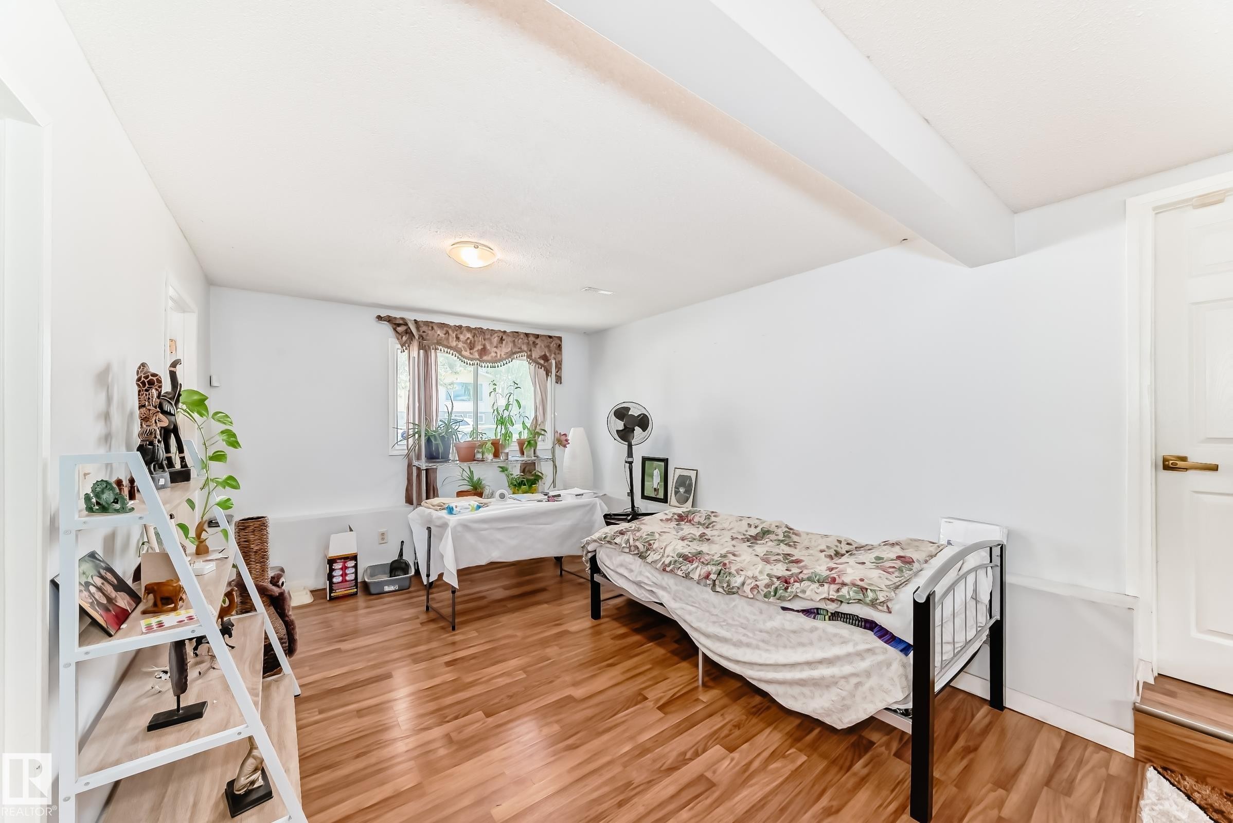 Bright room featuring wood-finish flooring and white walls - 1804 51 Street Nw, Edmonton, AB - Indoor