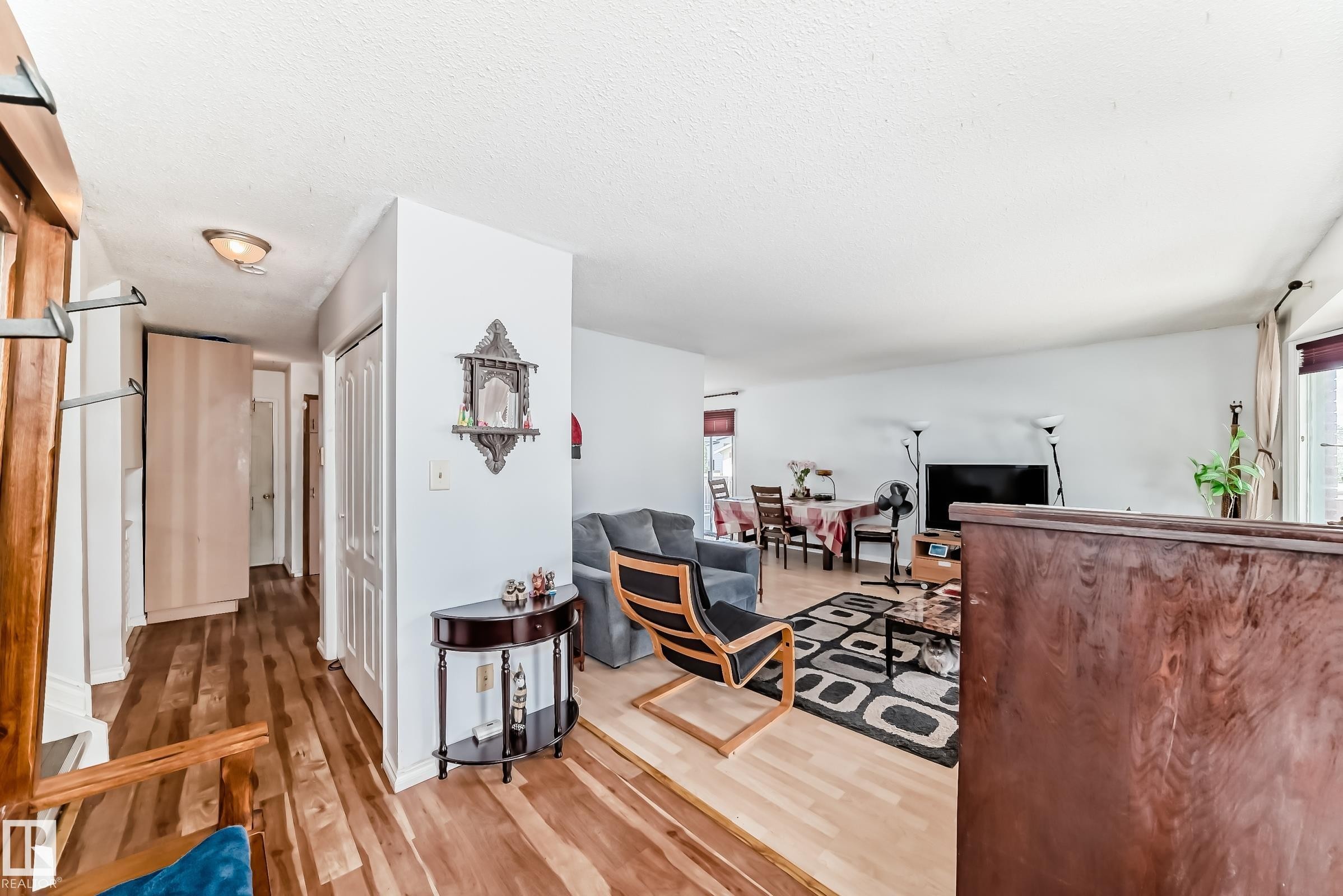 Hallway entry with wood-finish flooring, recessed lighting, and white panel doors - 1804 51 Street Nw, Edmonton, AB - Indoor