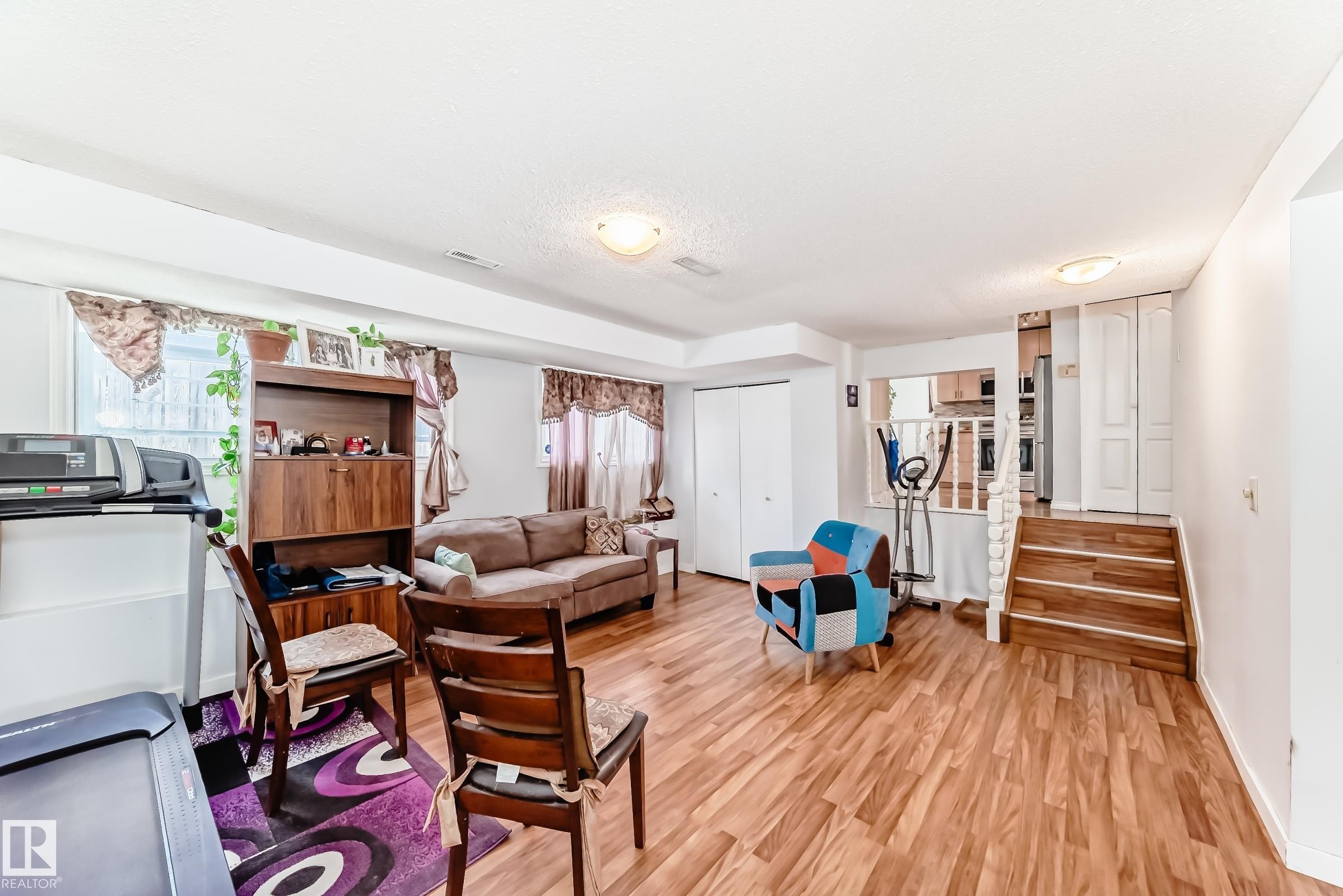 Expansive lower level featuring wood-finish flooring, recessed lighting, and bright white walls - 1804 51 Street Nw, Edmonton, AB - Indoor