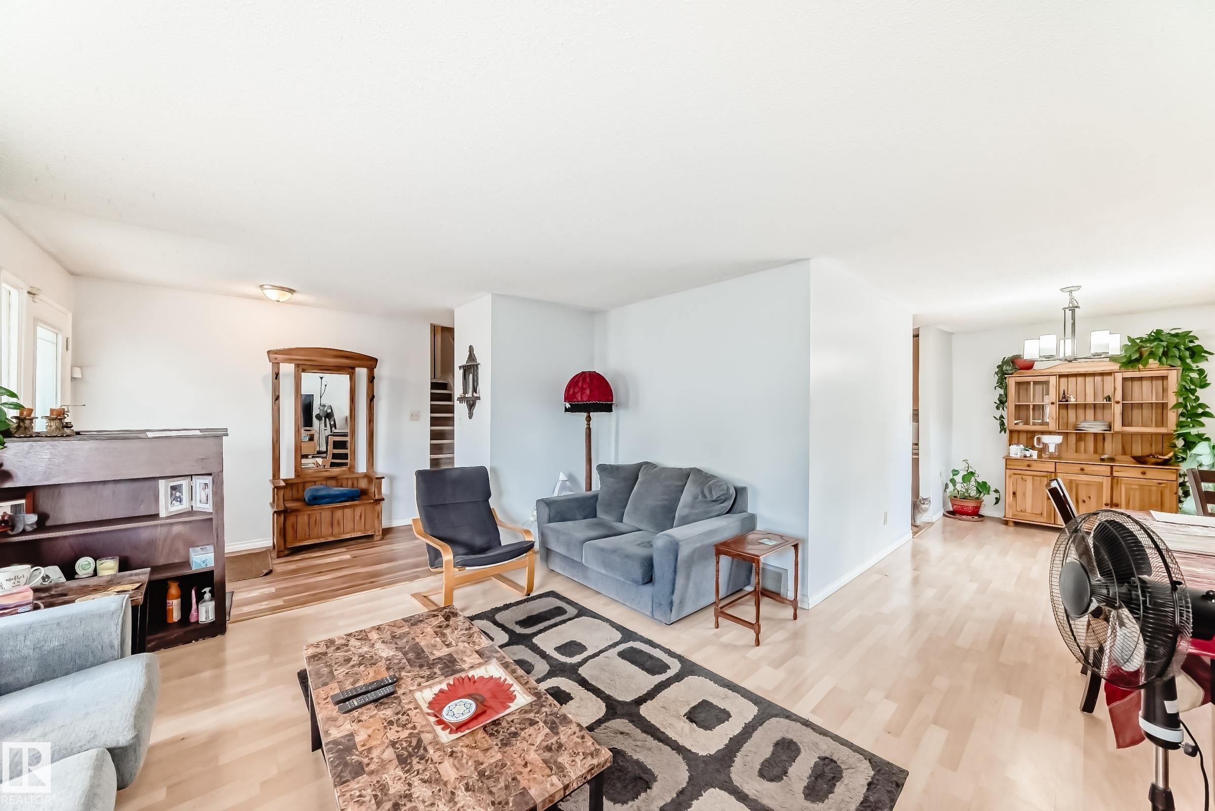 Open-concept living area featuring light wood-finish flooring, white walls, and a recessed ceiling light - 1804 51 Street Nw, Edmonton, AB - Indoor Photo Showing Living Room