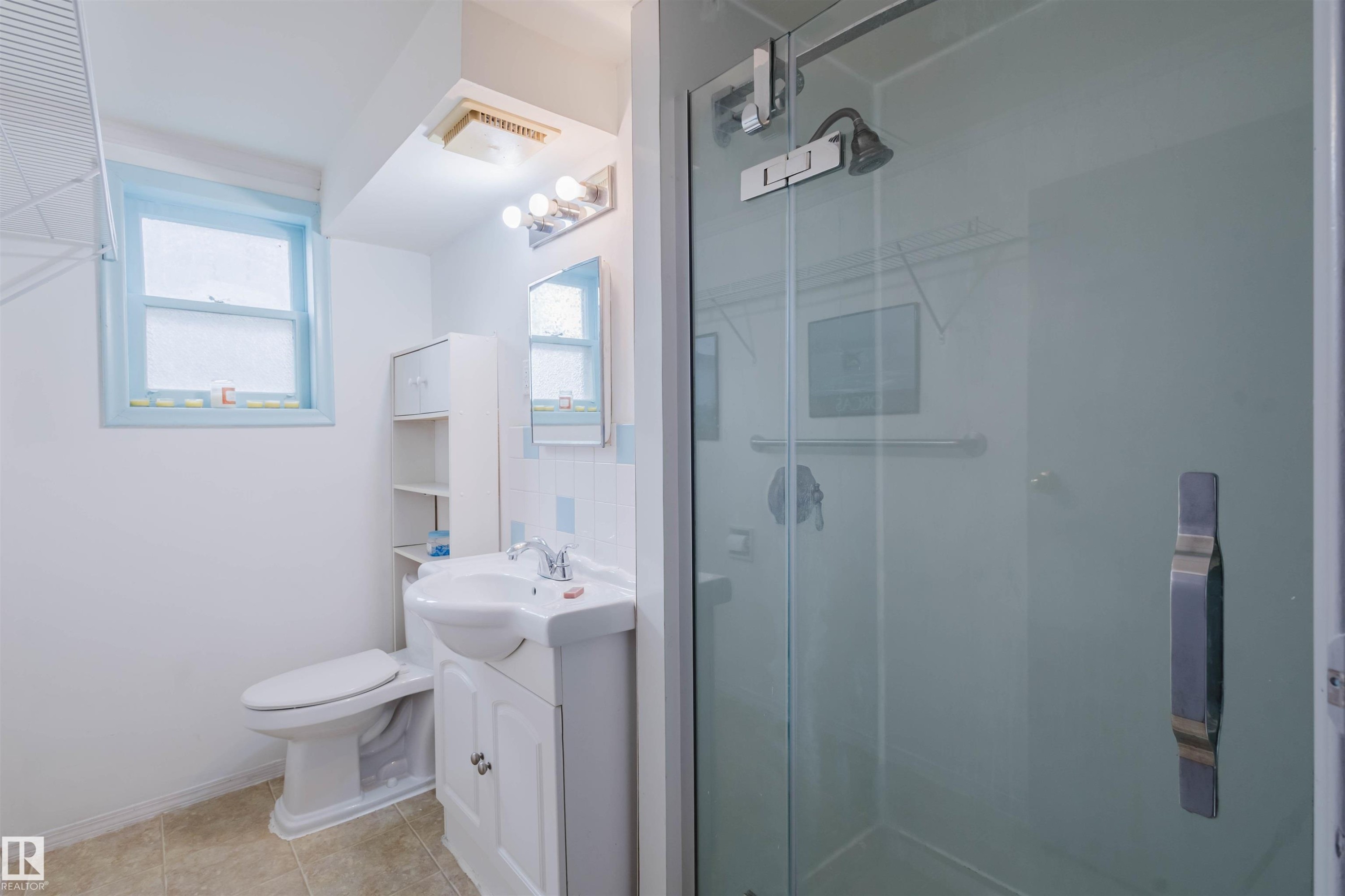 Glass-enclosed shower stall with a dark-finish shower head and hardware - 10511 80 Street, Edmonton, AB - Indoor Photo Showing Bathroom