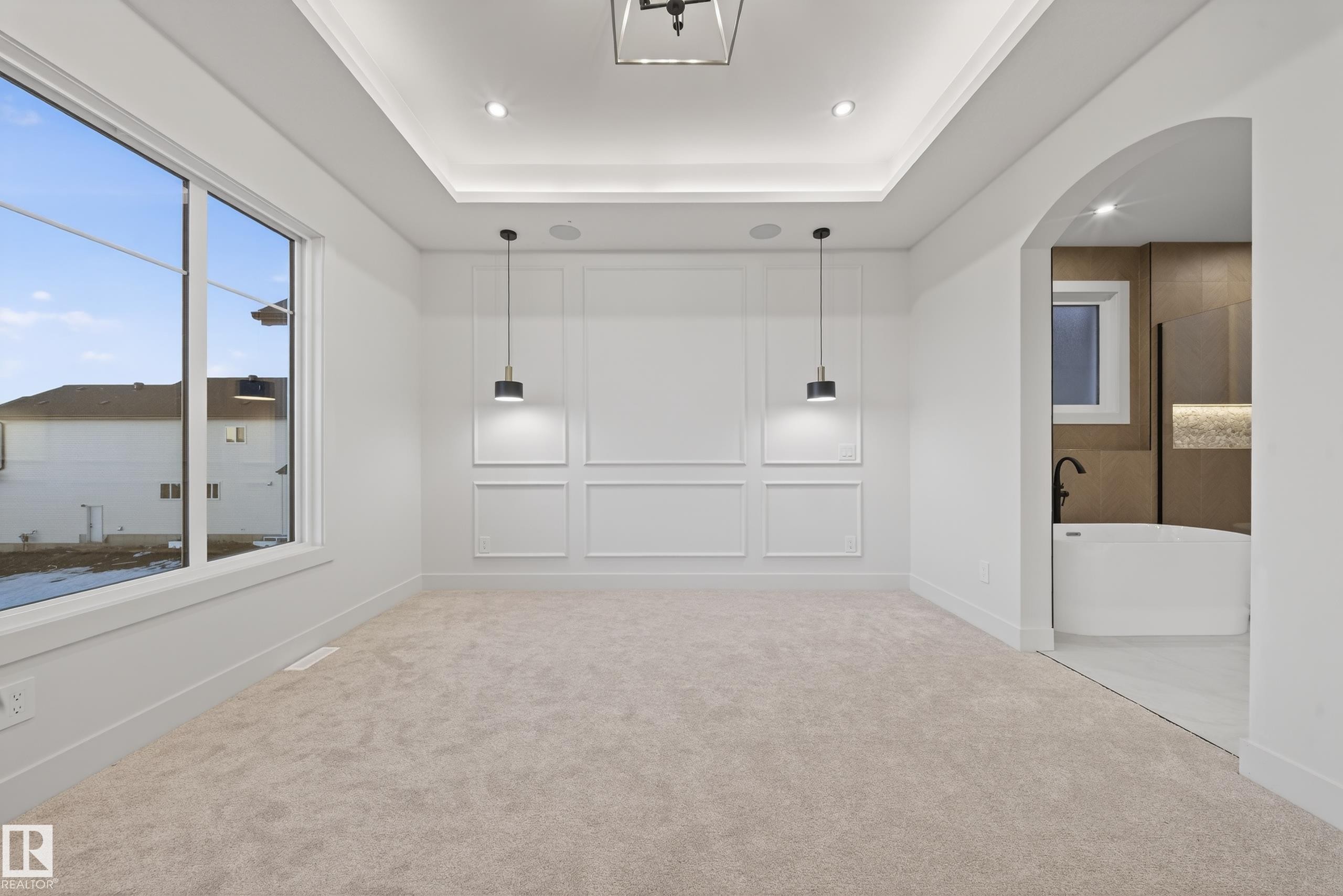 Spacious room with plush carpeting, large window, and decorative wall paneling - 4276 Charles Close, Edmonton, AB - Indoor Photo Showing Other Room