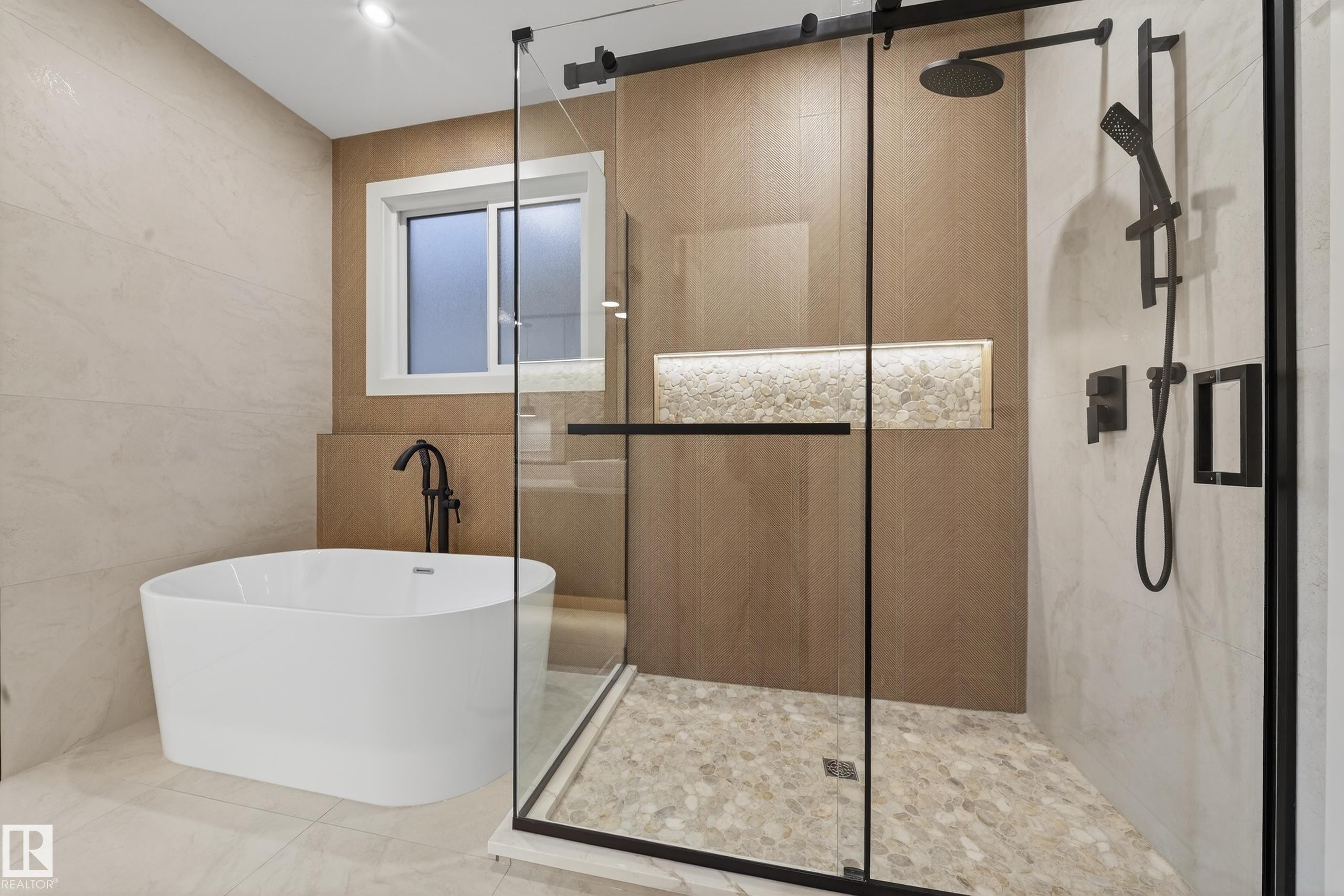 Contemporary bathroom featuring a freestanding soaking tub with a floor-mounted matte black faucet - 4276 Charles Close, Edmonton, AB - Indoor Photo Showing Bathroom