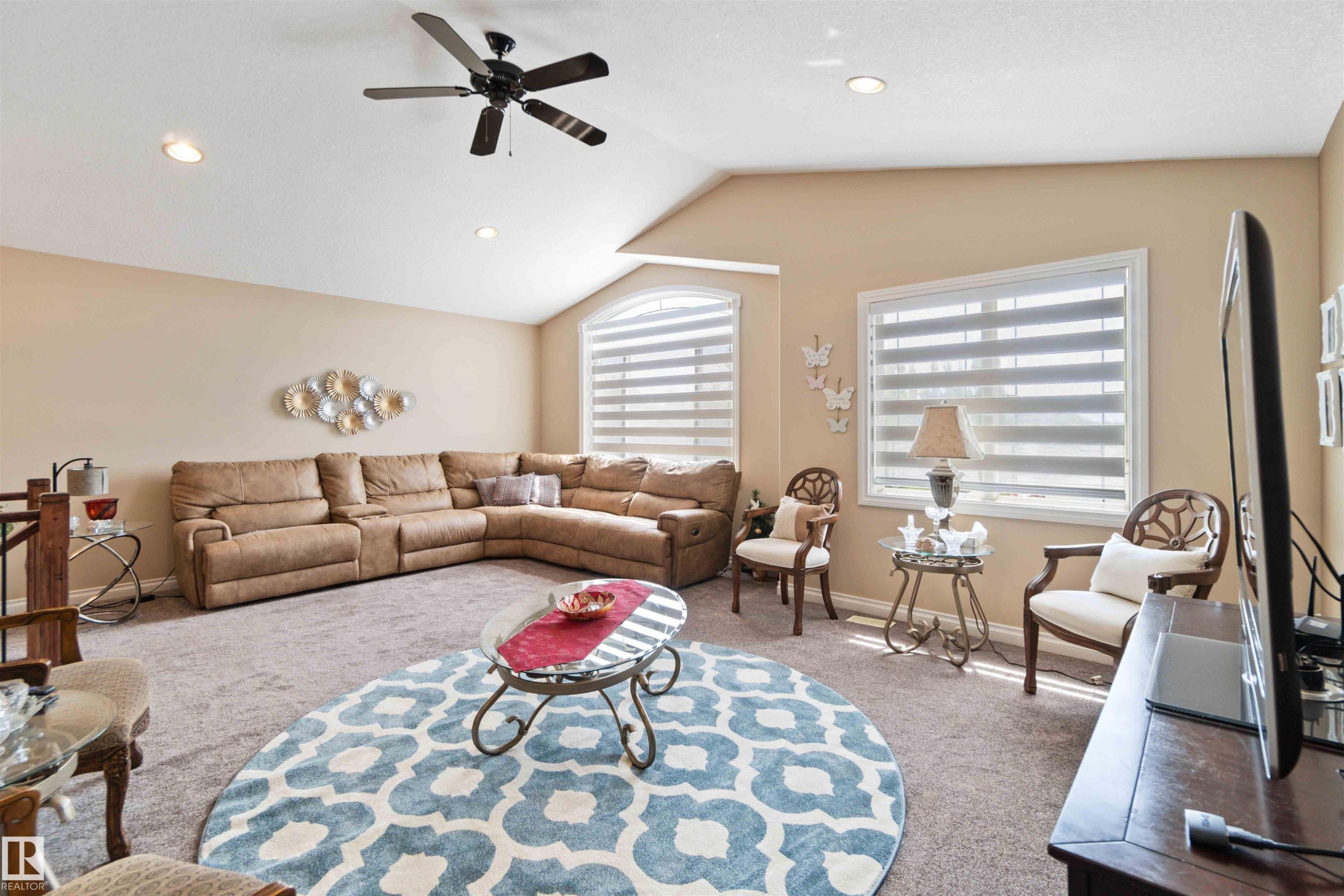 Spacious living area featuring vaulted ceilings, recessed lighting, and a ceiling fan - 6116 53 Avenue, Beaumont, AB - Indoor Photo Showing Living Room