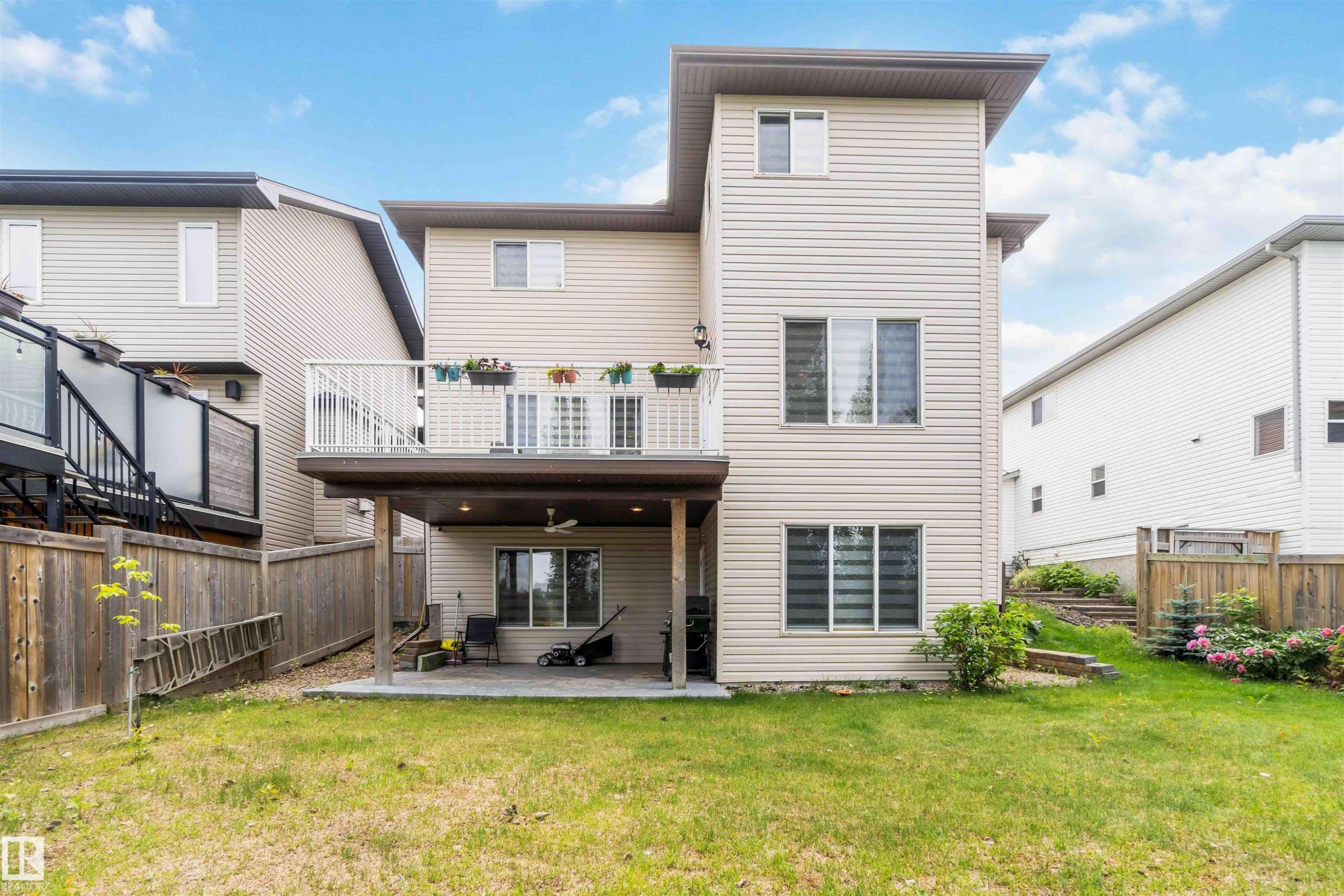 Beige vinyl siding exterior featuring multiple windows with blinds - 6116 53 Avenue, Beaumont, AB - Outdoor With Exterior