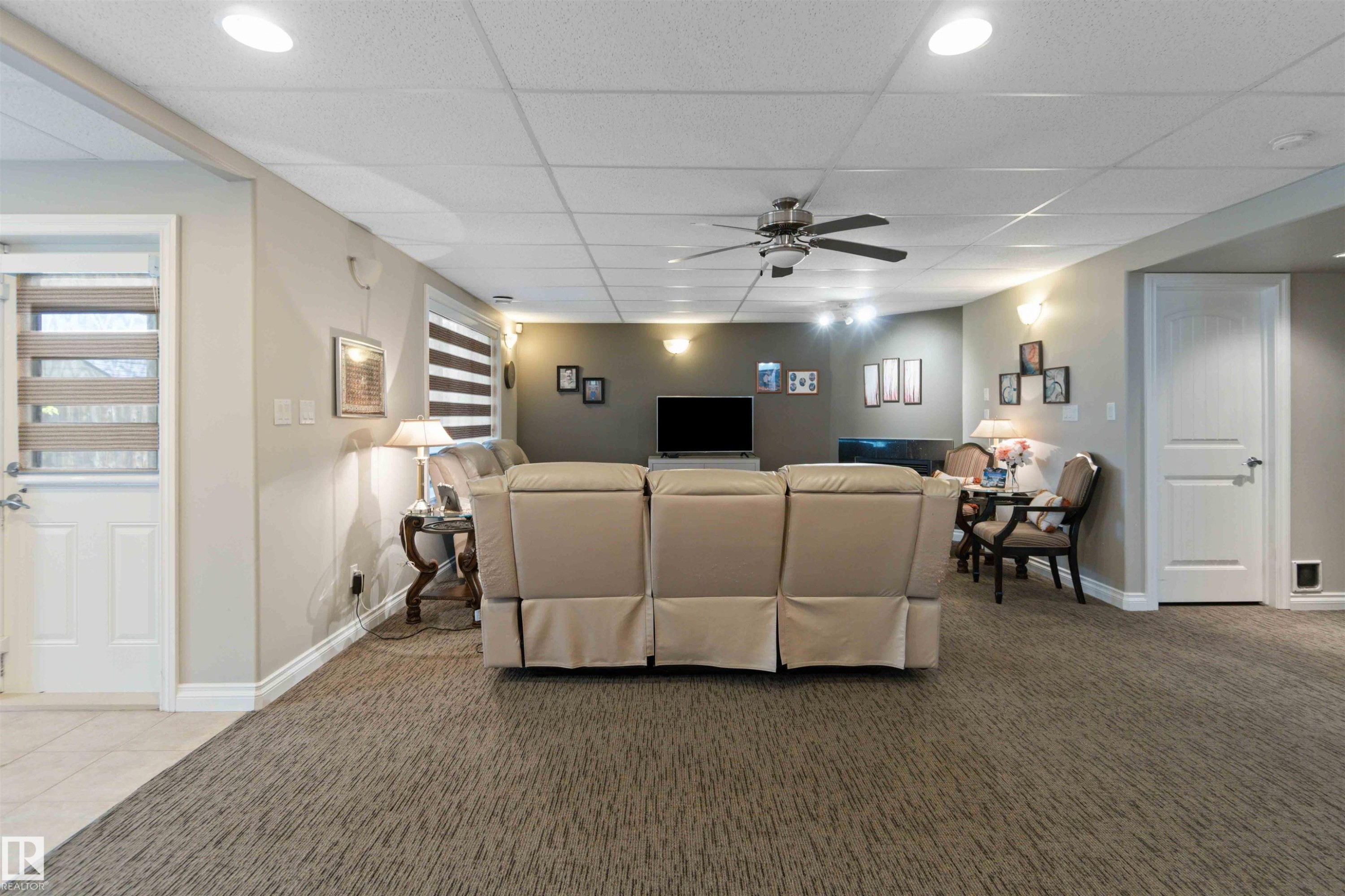 Finished lower level with patterned carpet flooring, recessed lighting, and drop ceiling - 6116 53 Avenue, Beaumont, AB - Indoor Photo Showing Other Room