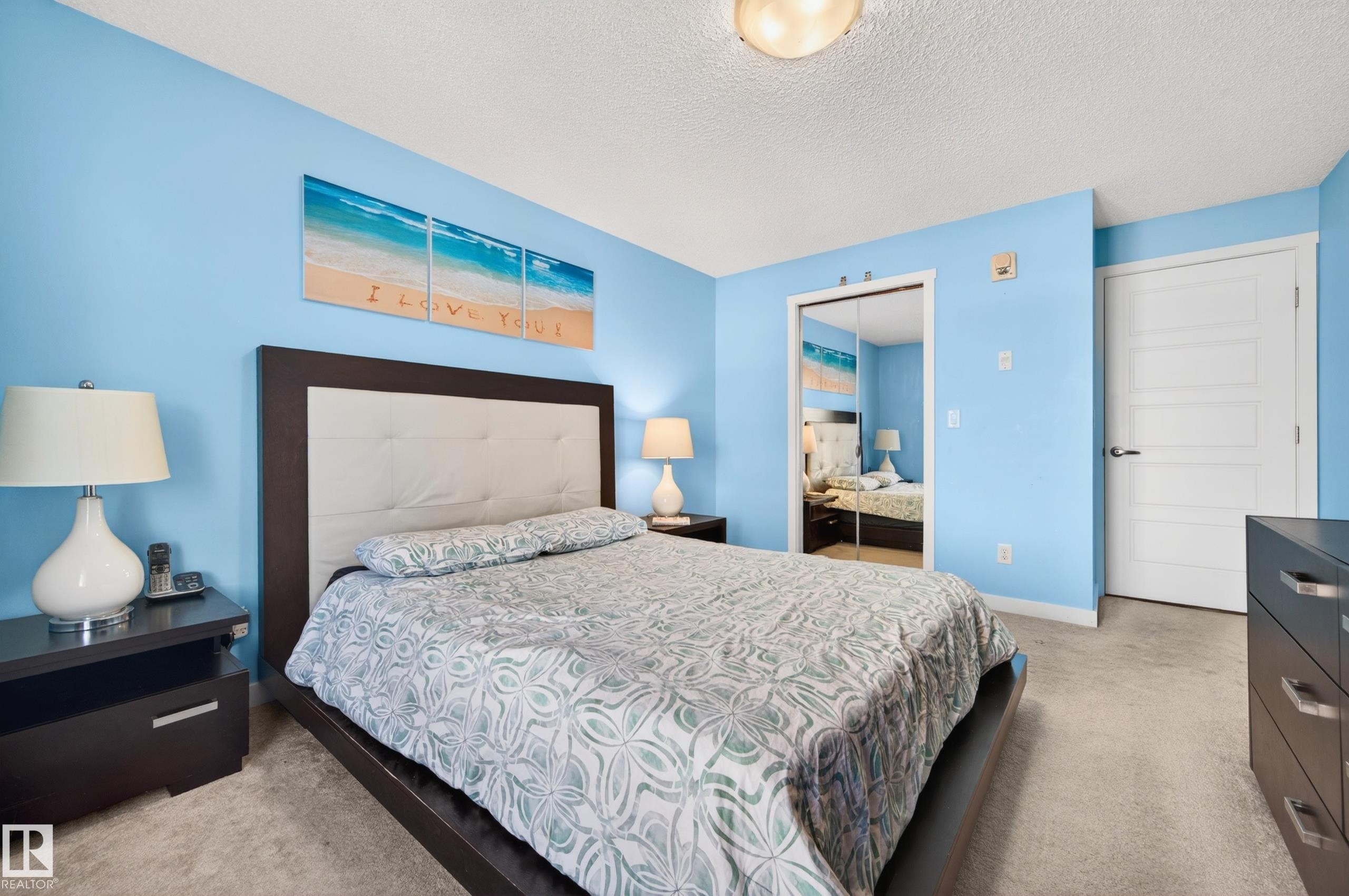 Interior space featuring carpeted flooring and light blue wall finishes - 340 6076 Schonsee Way, Edmonton, AB - Indoor Photo Showing Bedroom