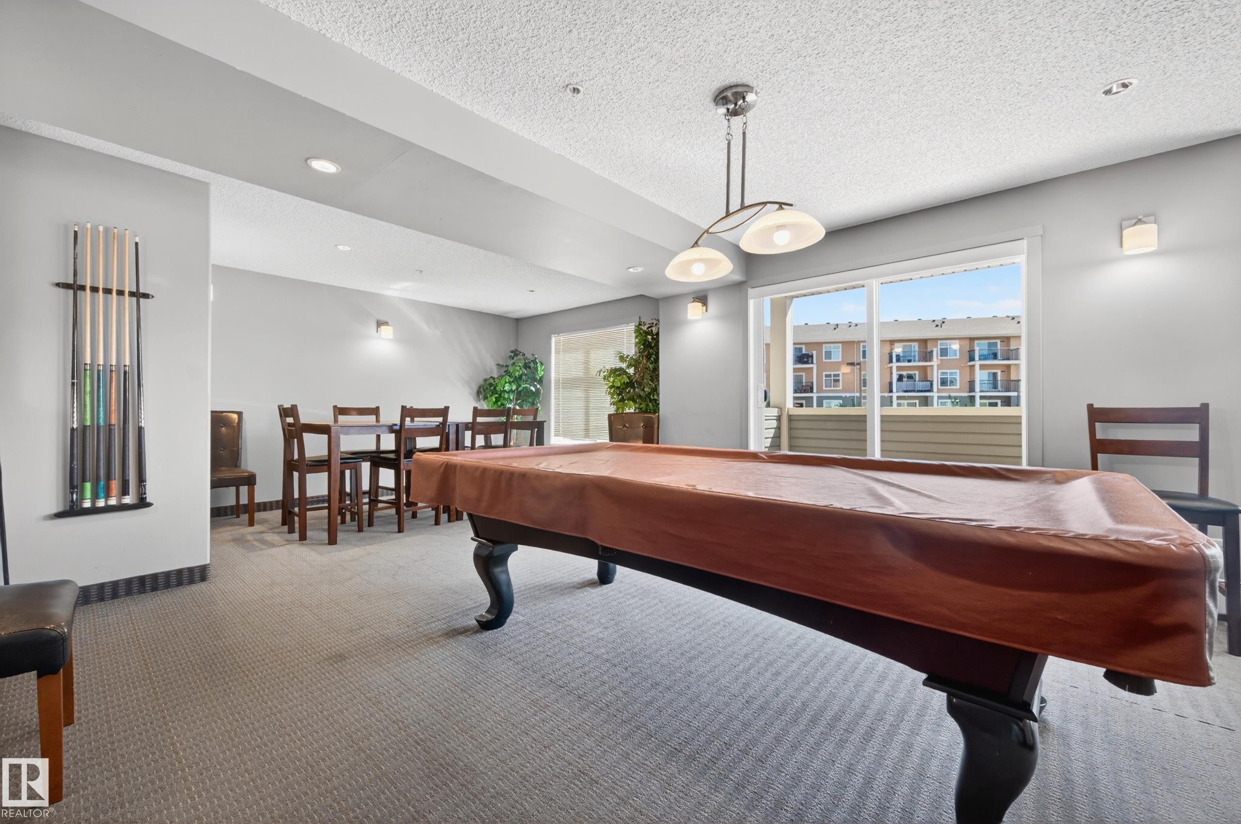 Recreation room featuring a pool table with a fitted cover, recessed lighting, and a built-in cue rack - 340 6076 Schonsee Way, Edmonton, AB - Indoor Photo Showing Other Room