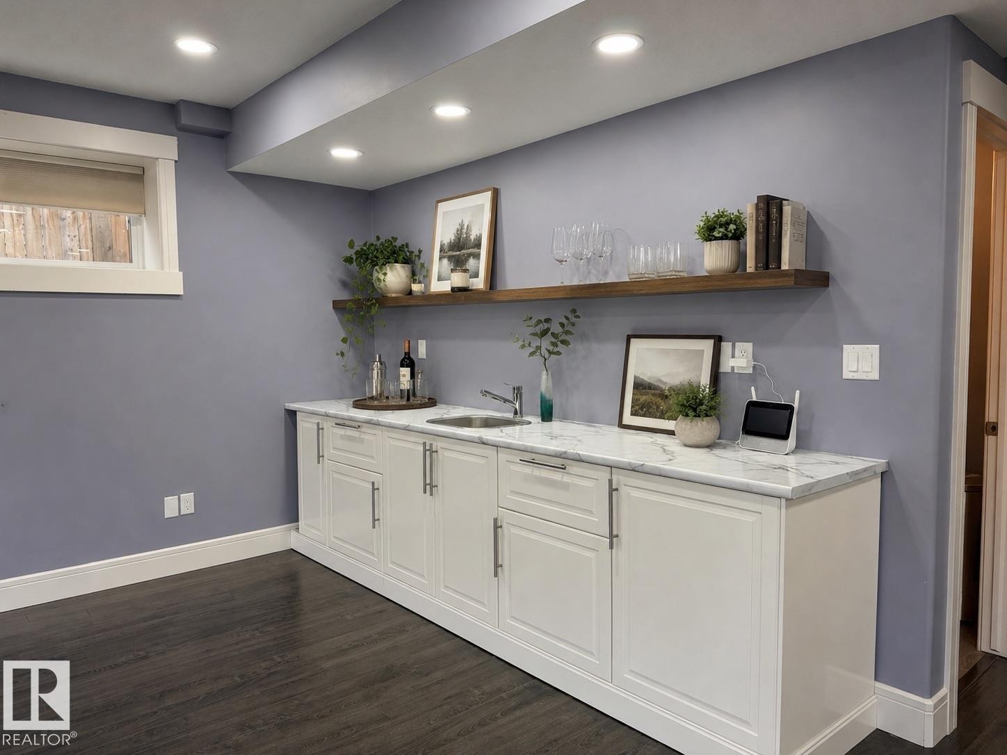 Wet bar featuring white shaker-style cabinetry with brushed nickel hardware, a rectangular undermount sink, and a white marble-look countertop - 648 178 Street, Edmonton, AB