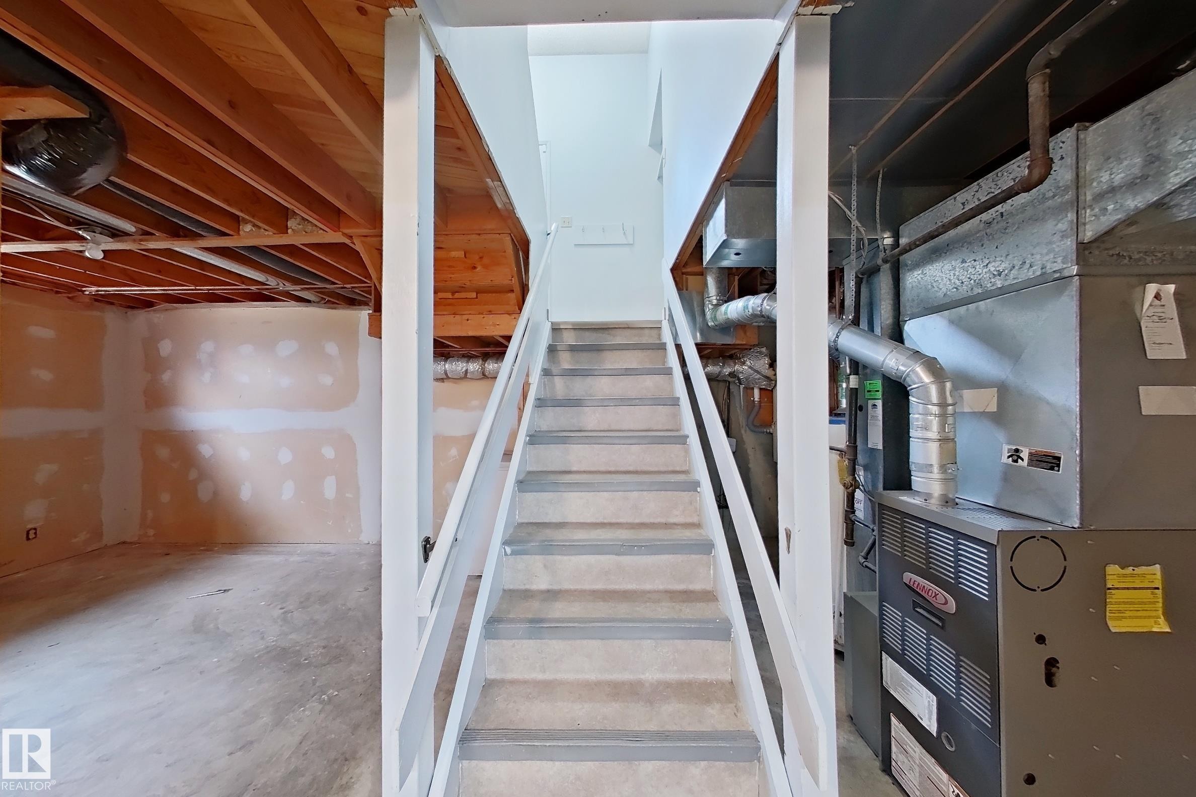 Staircase with painted treads and white railings - 1731 51 Street, Edmonton, AB - Indoor Photo Showing Basement