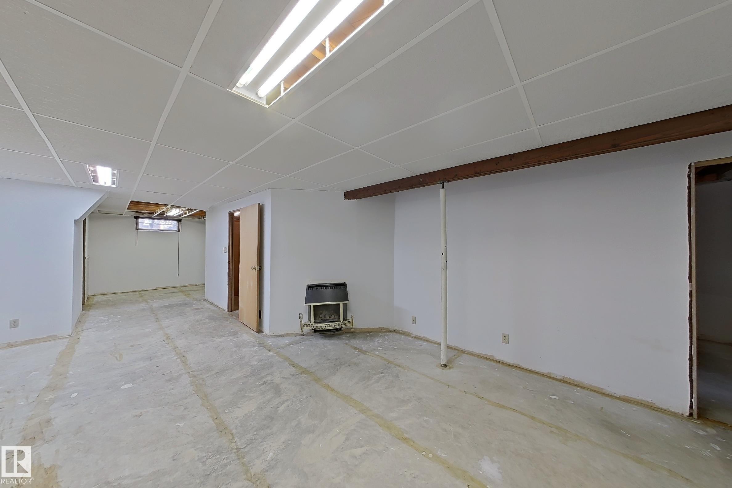 Spacious unfinished basement with exposed wood beam, drop ceiling, and concrete flooring - 1731 51 Street, Edmonton, AB - Indoor
