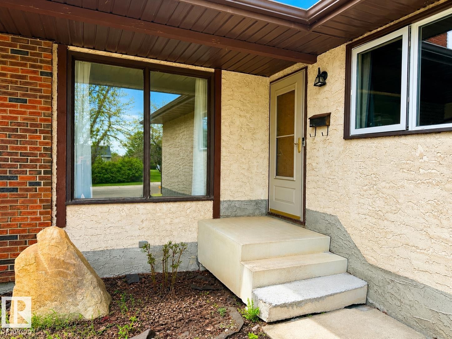 Front entry featuring textured stucco and brick facade - 1731 51 Street, Edmonton, AB - Outdoor With Deck Patio Veranda With Exterior