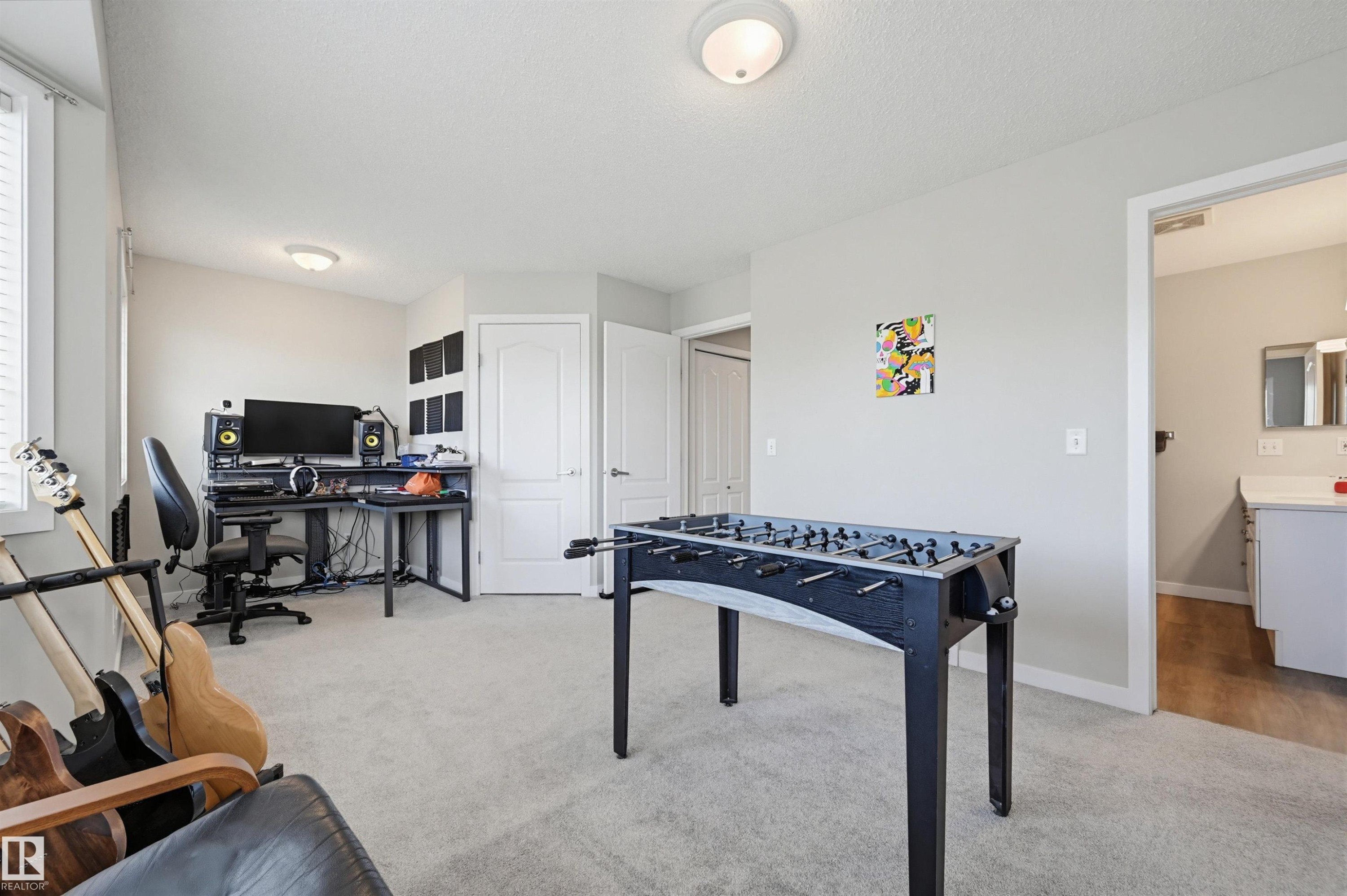 Spacious room featuring light gray carpeting and light neutral wall paint - 11 3380 28A Avenue Nw, Edmonton, AB - Indoor Photo Showing Bedroom