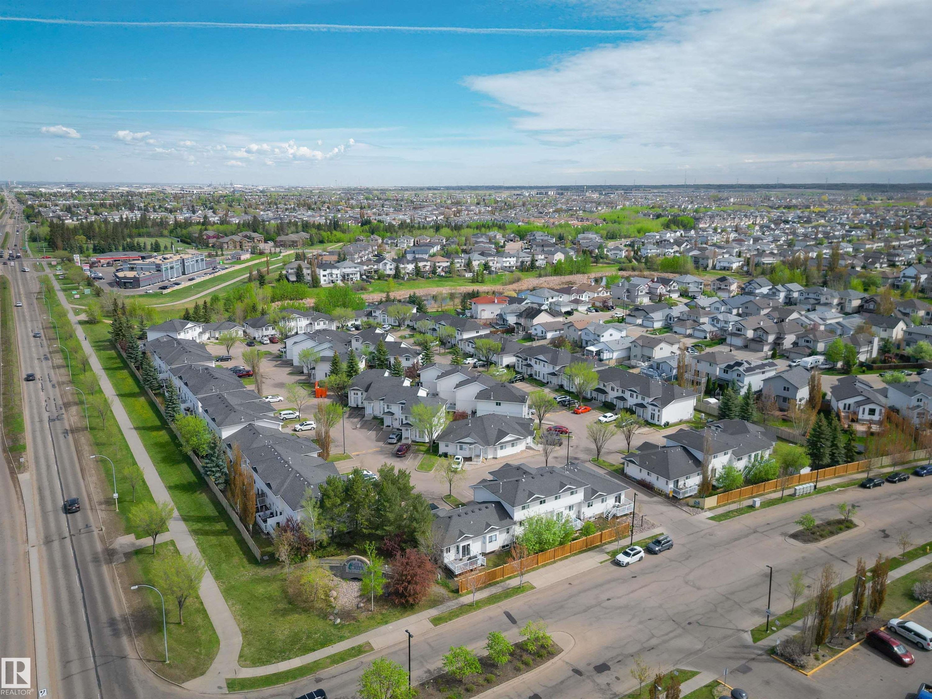 Aerial perspective showcasing a residential community with a mix of detached homes and townhome-style residences - 11 3380 28A Avenue Nw, Edmonton, AB - Outdoor With View