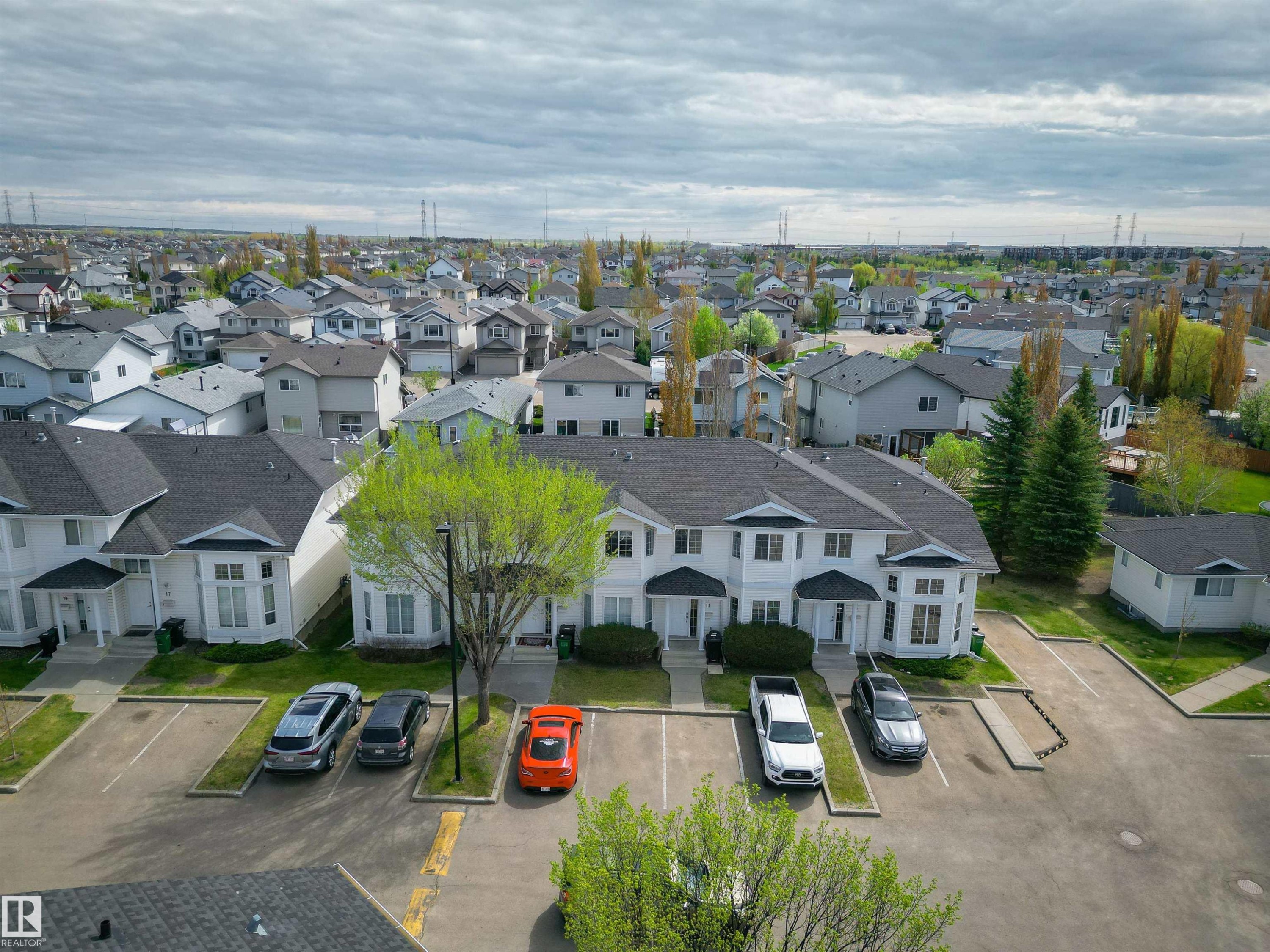 Multi-unit property featuring white siding and dark shingle roofing - 11 3380 28A Avenue Nw, Edmonton, AB - Outdoor With View