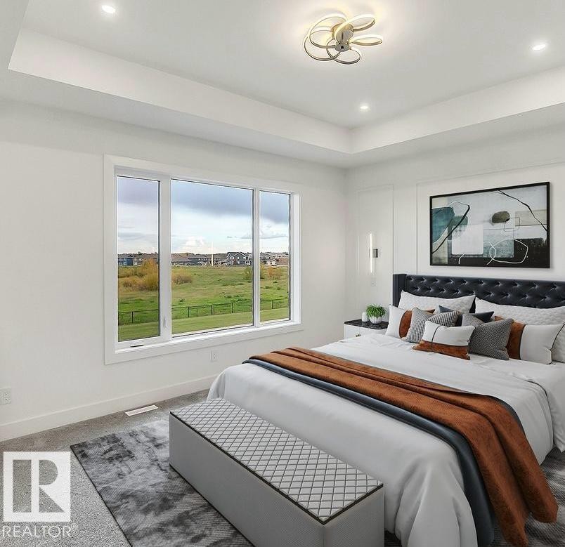 Bright bedroom featuring a large multi-pane window, recessed lighting, and a modern ceiling fixture - 13032 186 Avenue, Edmonton, AB - Indoor Photo Showing Bedroom