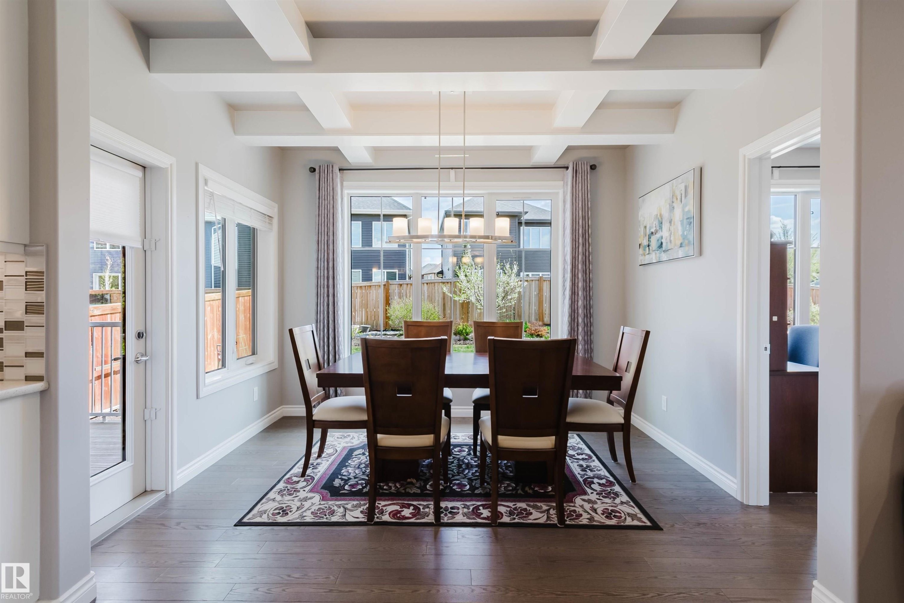 Dining area featuring coffered ceilings and wood-finish flooring - 3571 Keswick Boulevard, Edmonton, AB - Indoor Photo Showing Dining Room