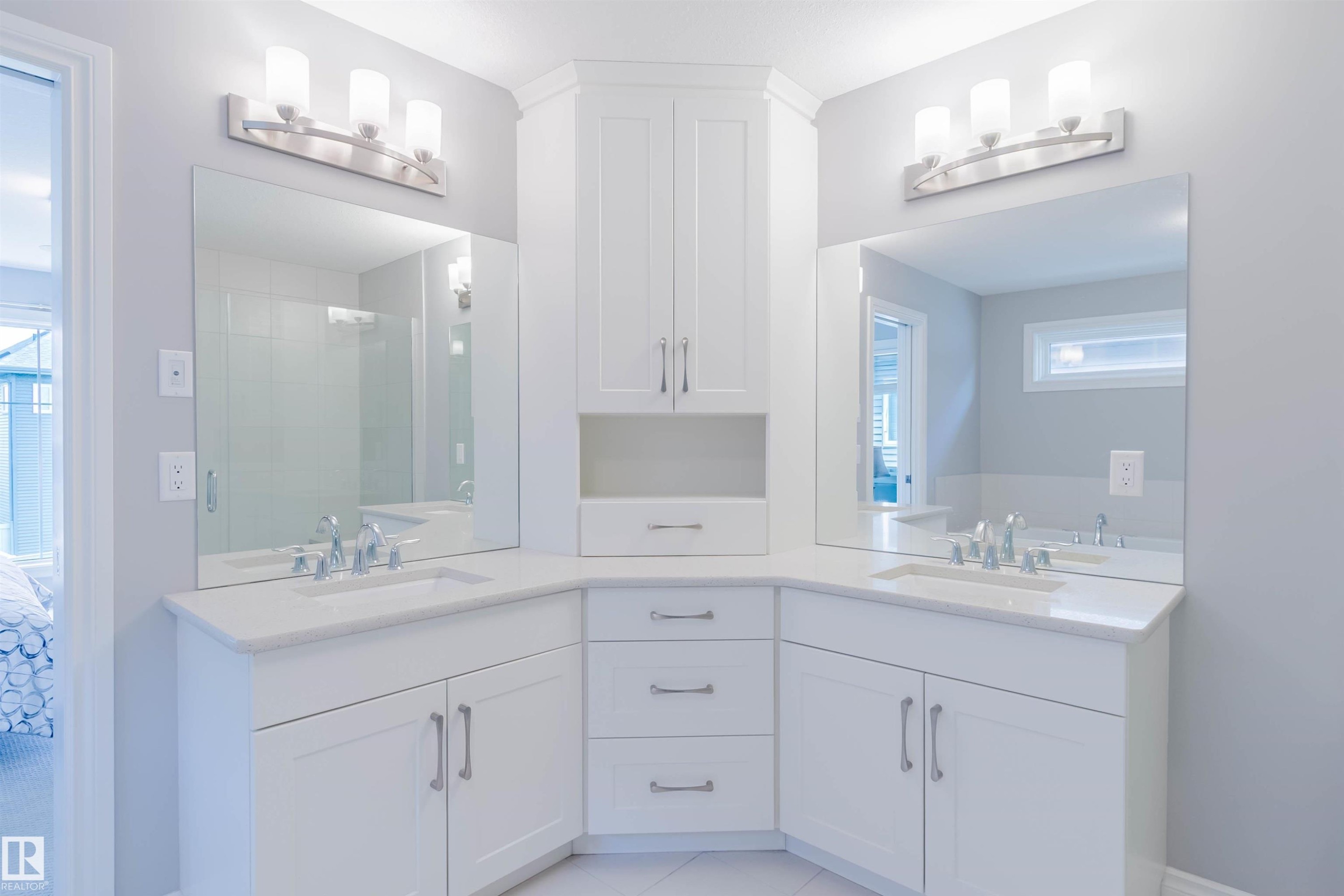 Dual vanity featuring white shaker-style cabinetry, white countertops, undermount sinks, and brushed nickel hardware - 3571 Keswick Boulevard, Edmonton, AB - Indoor Photo Showing Bathroom