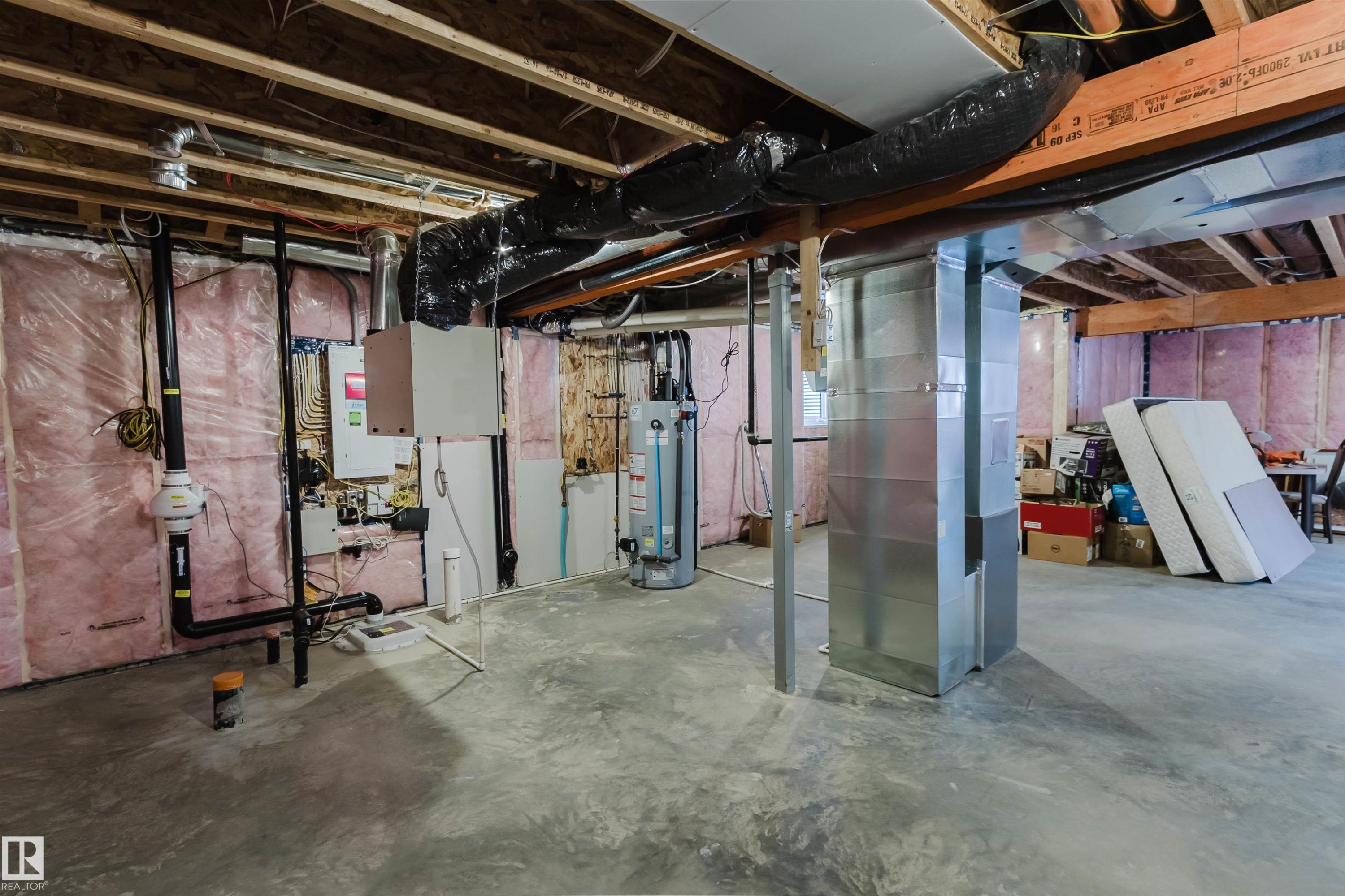 Unfinished basement with concrete flooring and exposed joists, featuring a hot water heater and HVAC ductwork - 3571 Keswick Boulevard, Edmonton, AB - Indoor Photo Showing Basement