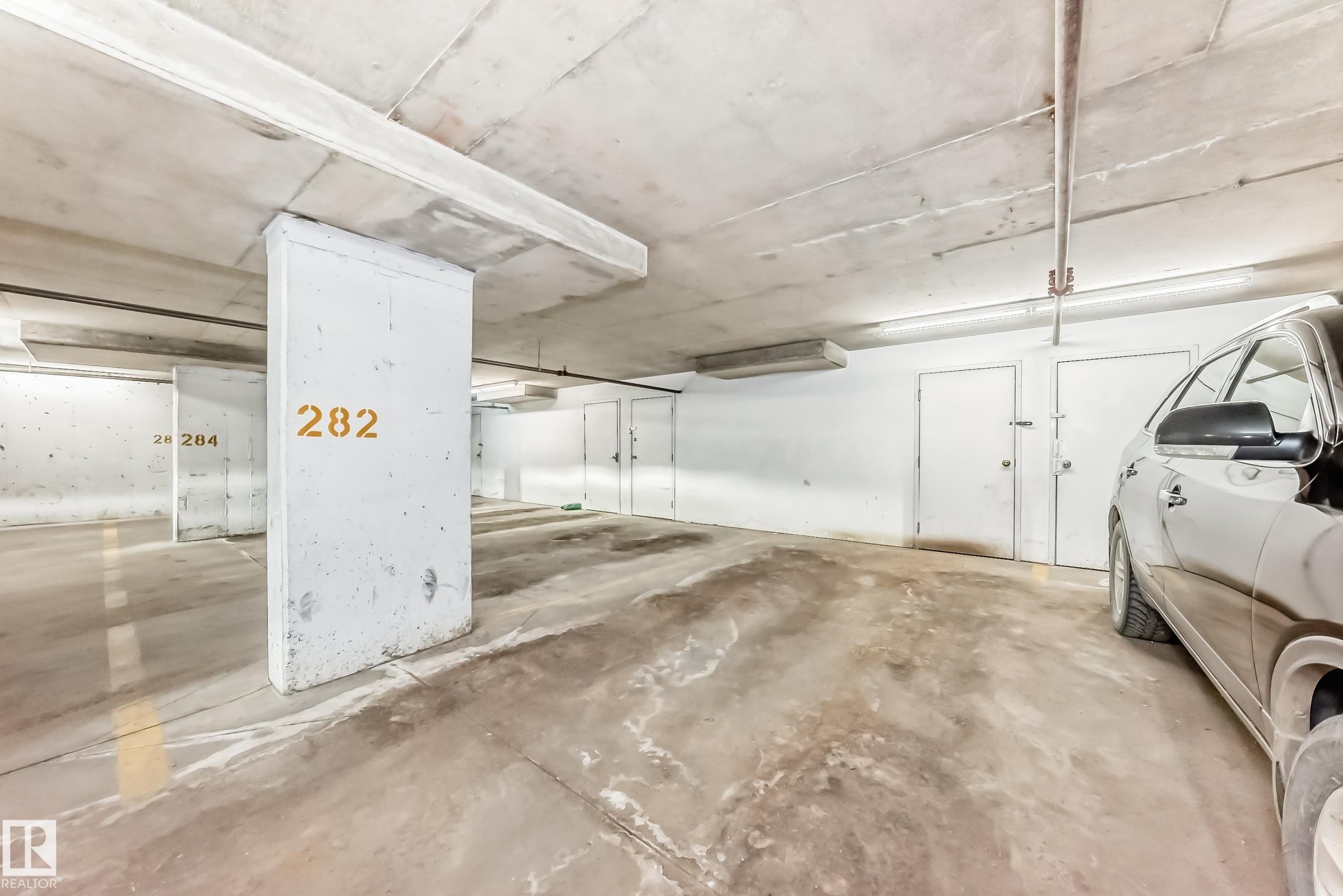 Dedicated parking space with a concrete floor and clear overhead lighting - 101 530 Watt Boulevard, Edmonton, AB - Indoor Photo Showing Garage