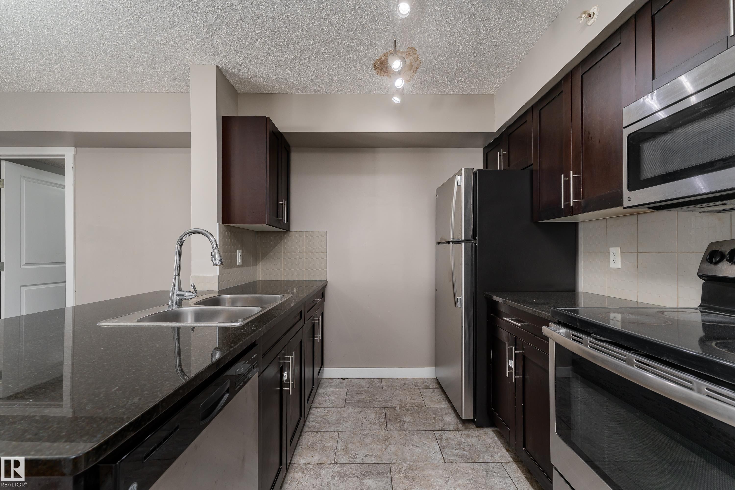 409 5804 Mullen Place, Edmonton, AB - Indoor Photo Showing Kitchen With Stainless Steel Kitchen With Double Sink