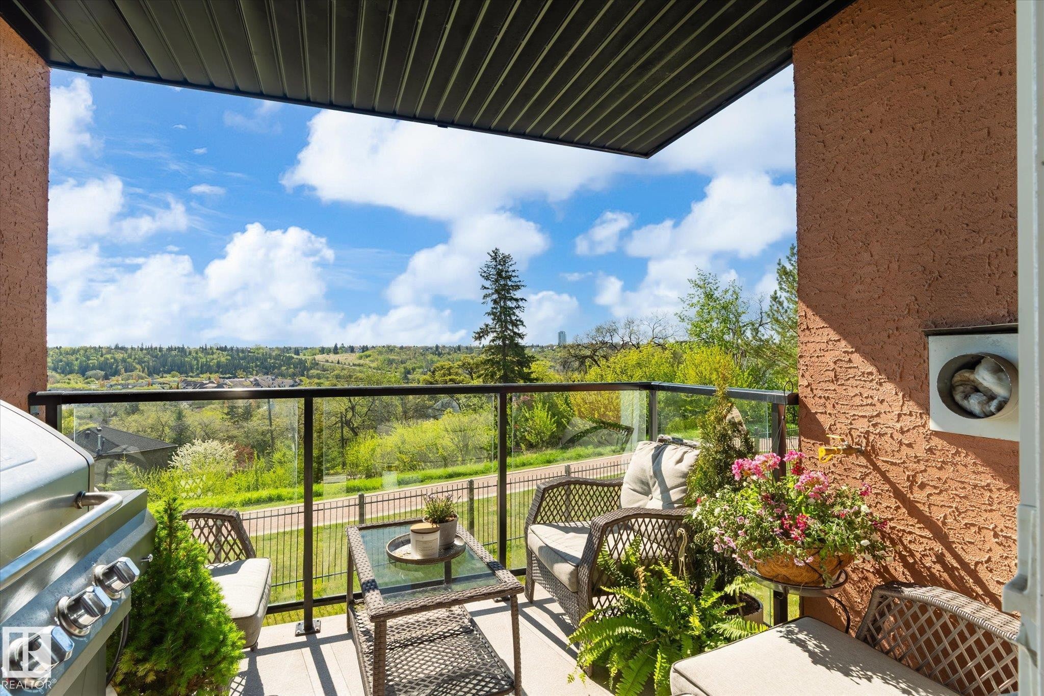 Private balcony featuring a glass railing and a stucco exterior wall - 108 10105 95 Street, Edmonton, AB - Outdoor With Balcony With Exterior