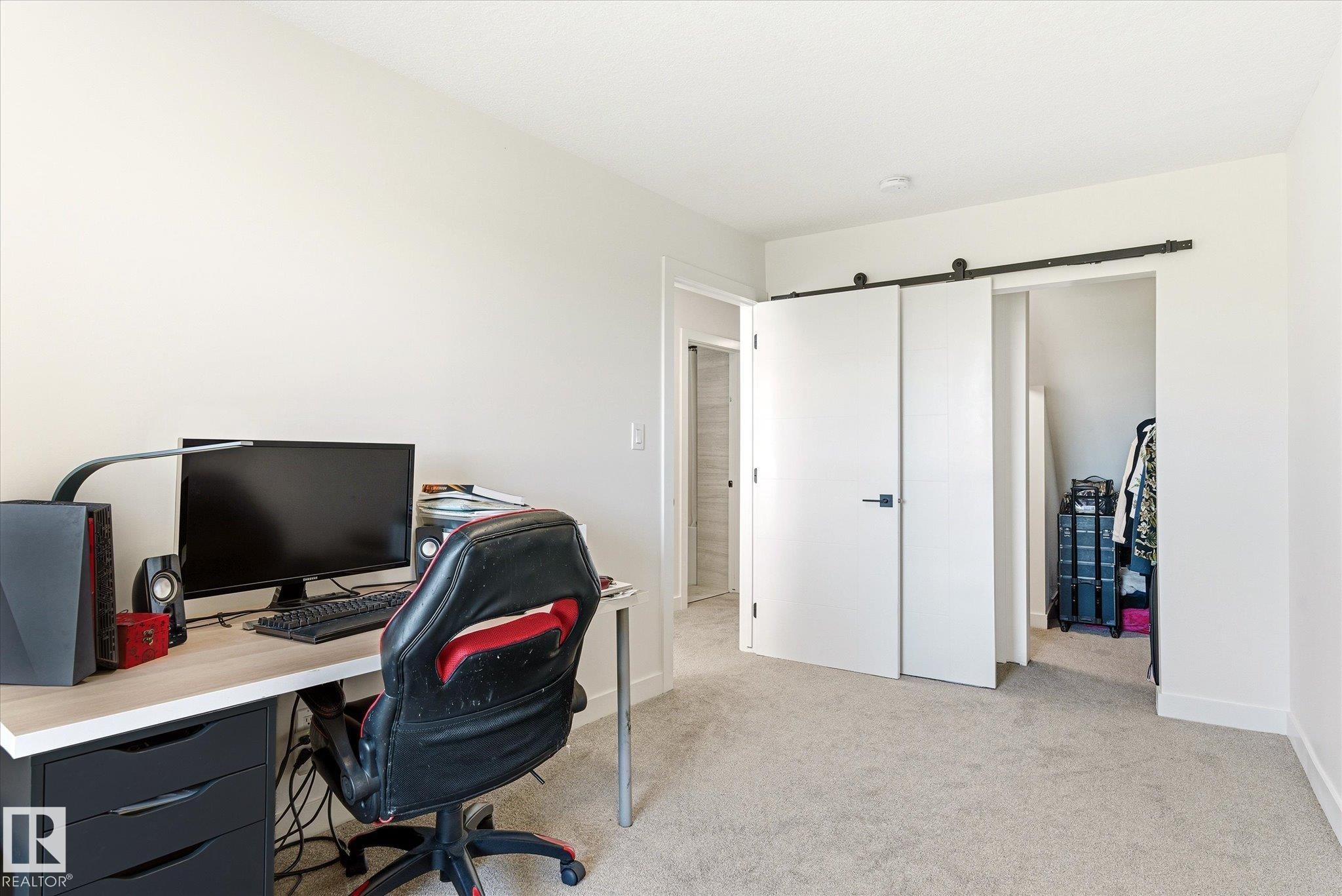 Neutral-toned room featuring light carpet flooring and white walls - 108 10105 95 Street, Edmonton, AB - Indoor Photo Showing Office