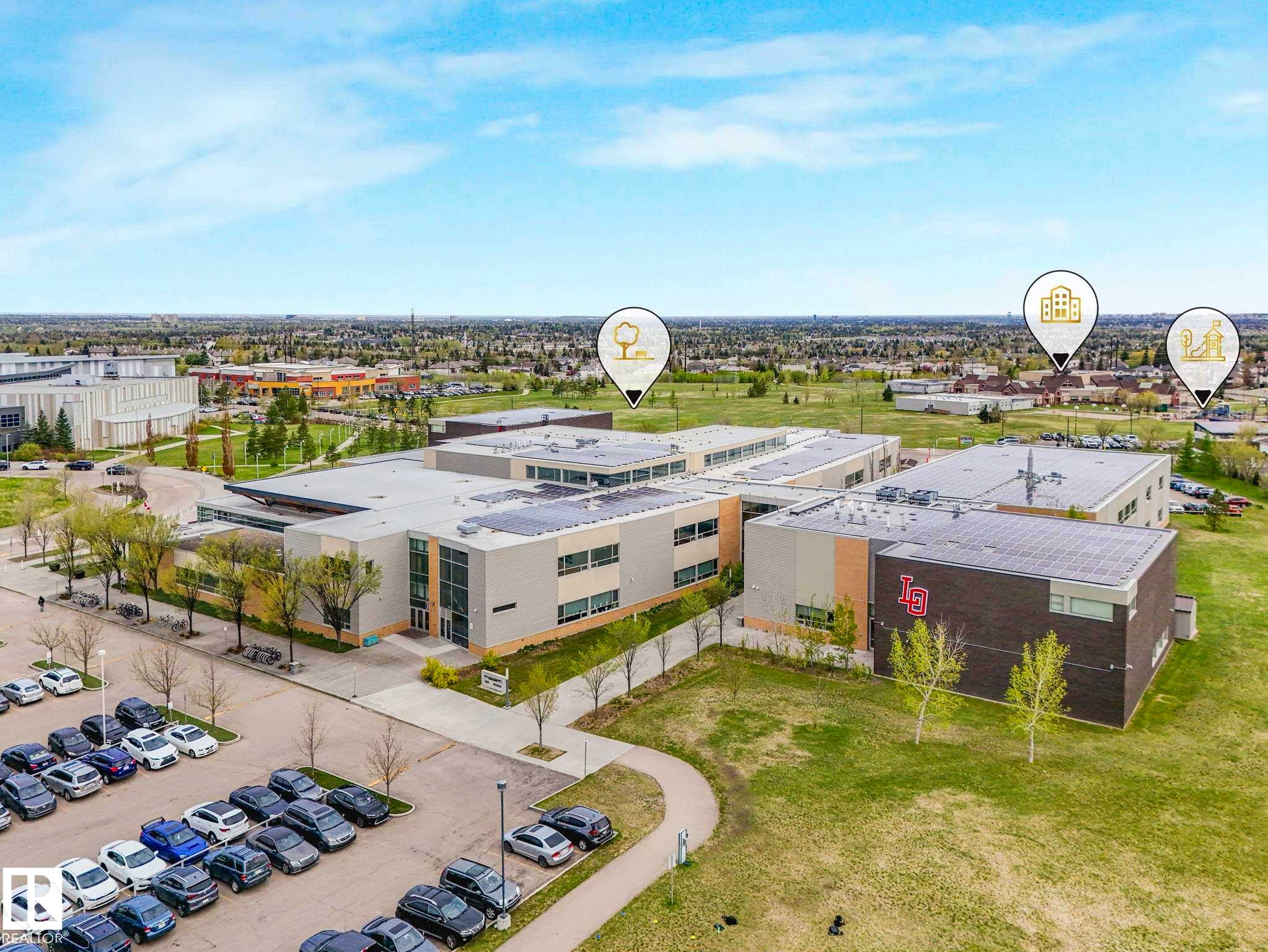 Expansive campus featuring multiple modern buildings with flat roofs and solar panel installations - 213 625 Leger Way, Edmonton, AB - Outdoor With View
