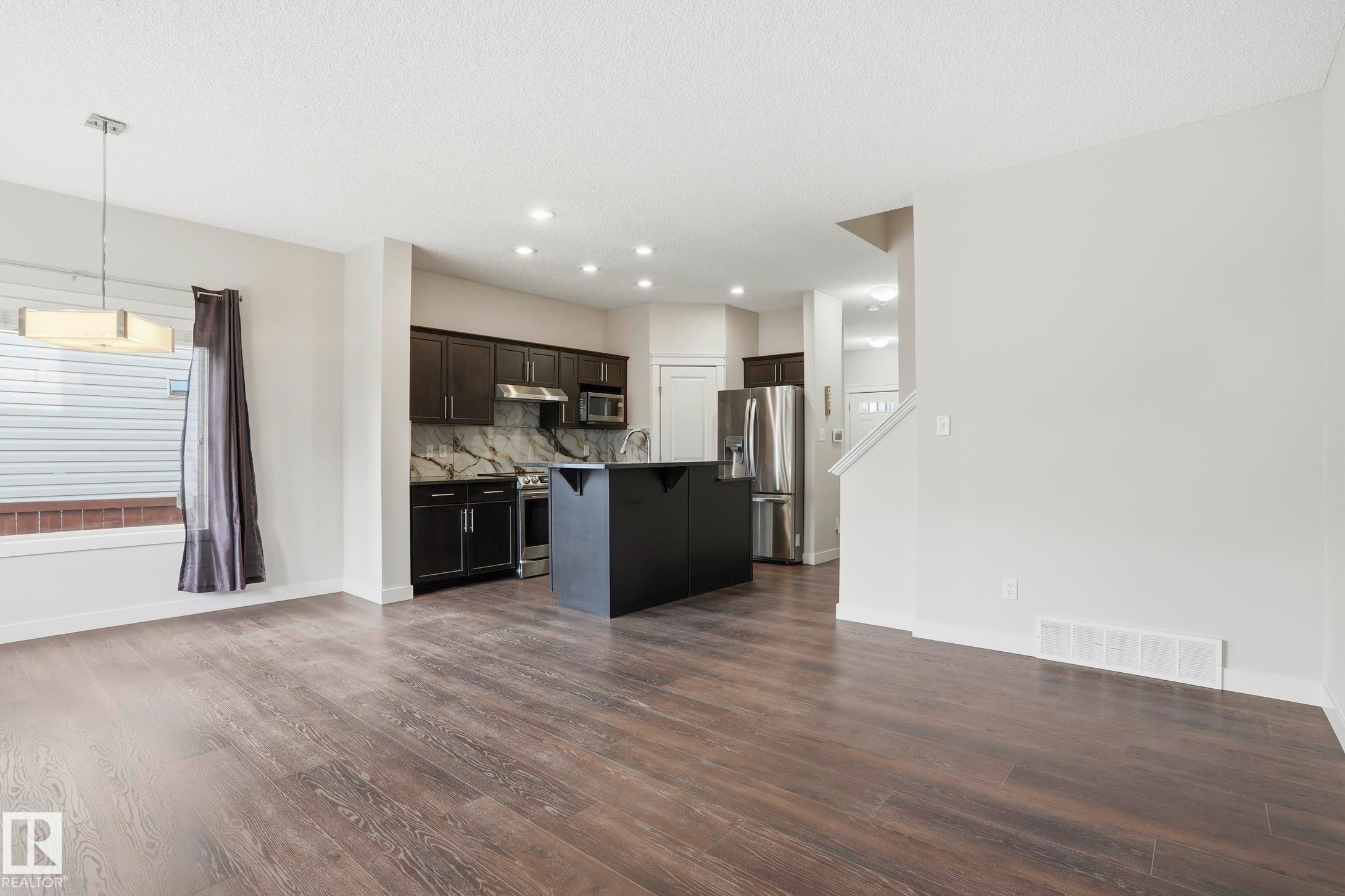 Open-concept living area featuring wood-finish flooring and recessed lighting - 2917 16A Avenue, Edmonton, AB - Indoor Photo Showing Kitchen